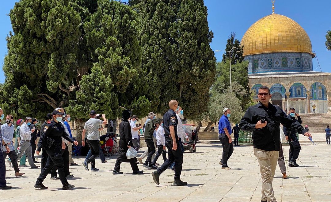 Israeli police walking across the Al-Aqsa compound