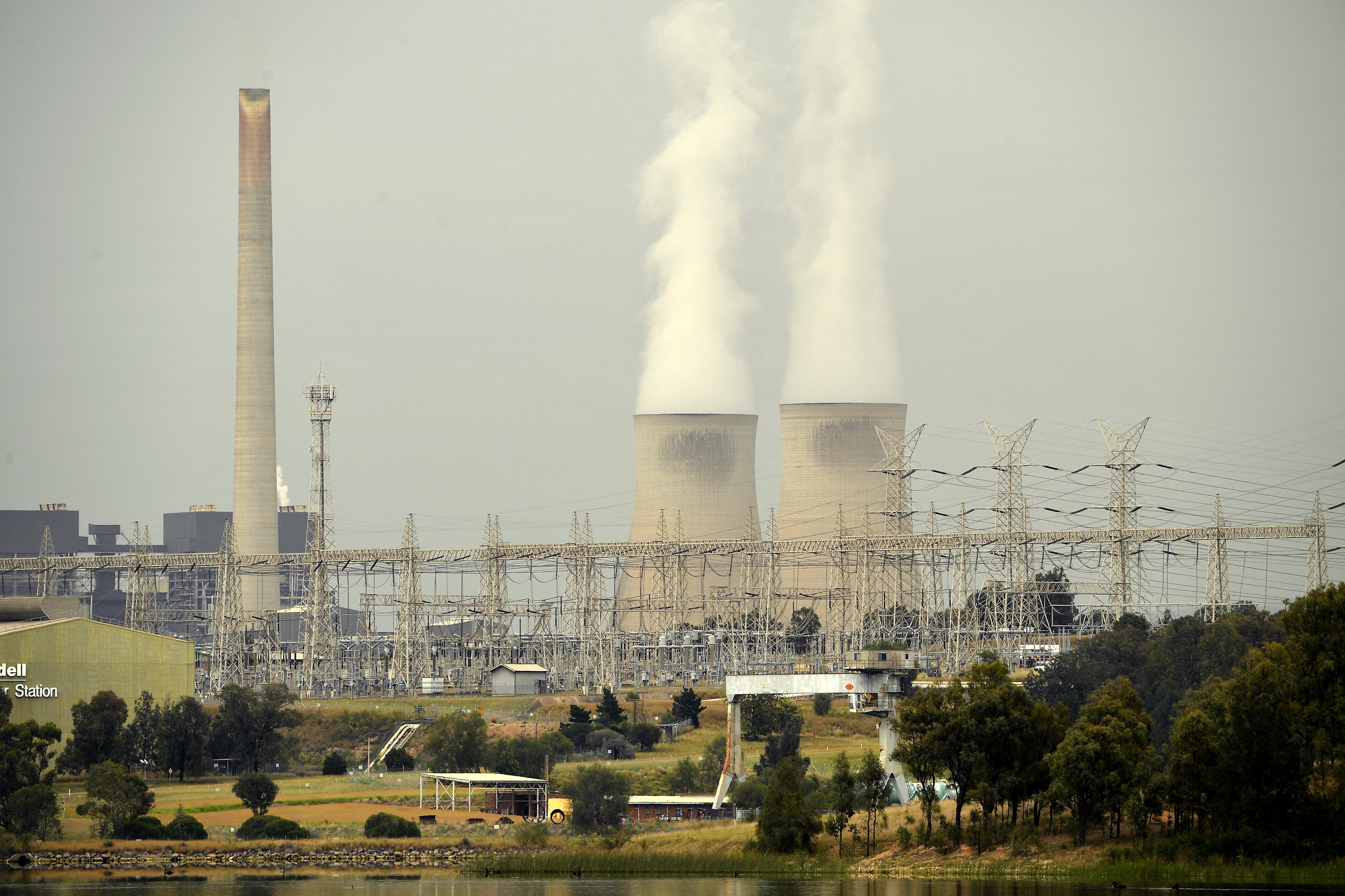 Smoke billows from the cooling towers of a coal fired power station in australia