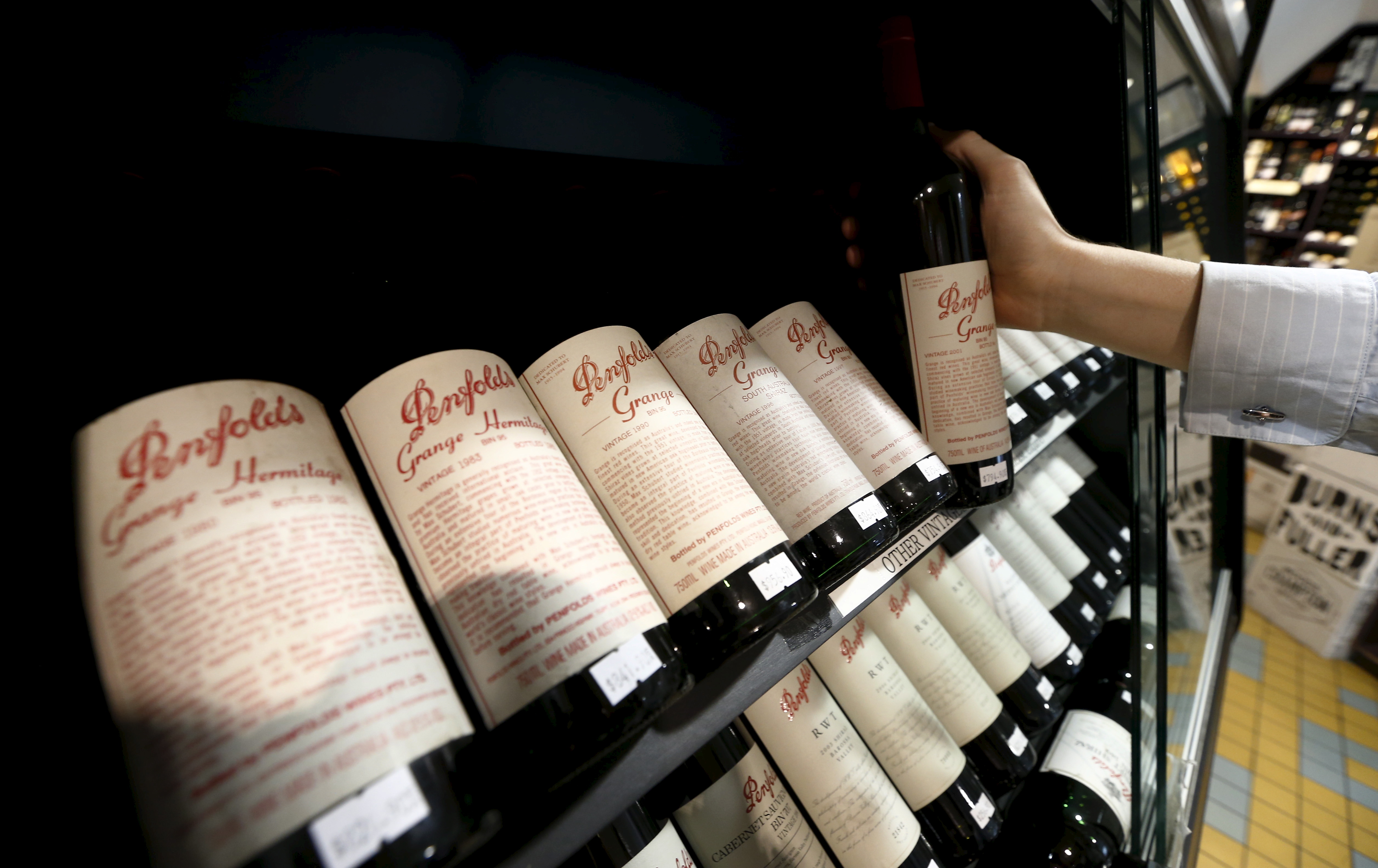 A bottle of Penfolds Grange wine is selected at a Sydney boutique wine store