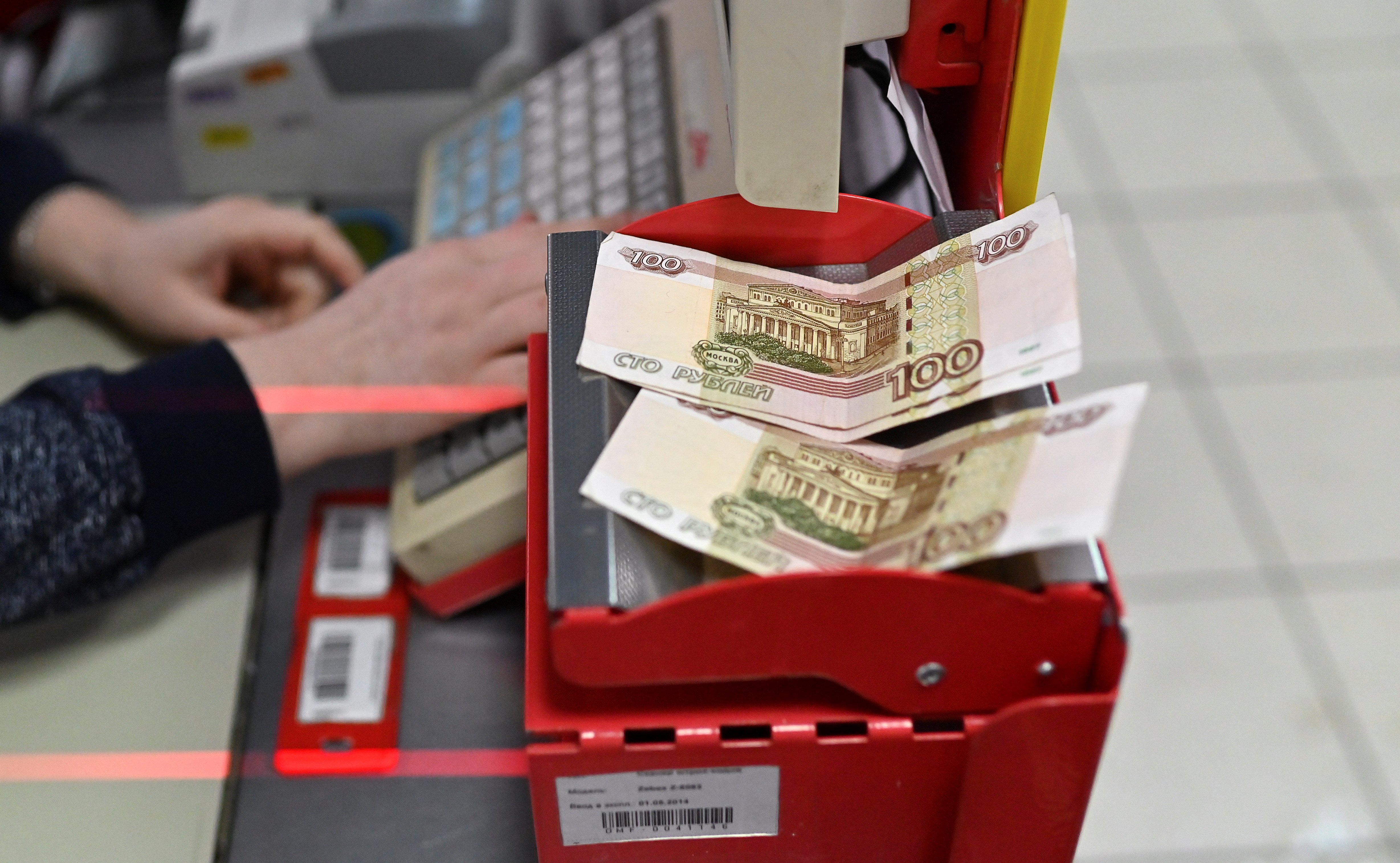 Russian 100-rouble banknotes are placed on a cashier's desk at a supermarket in the Siberian town of Tara in the Omsk region, Russia, December 14, 2021. Picture taken December