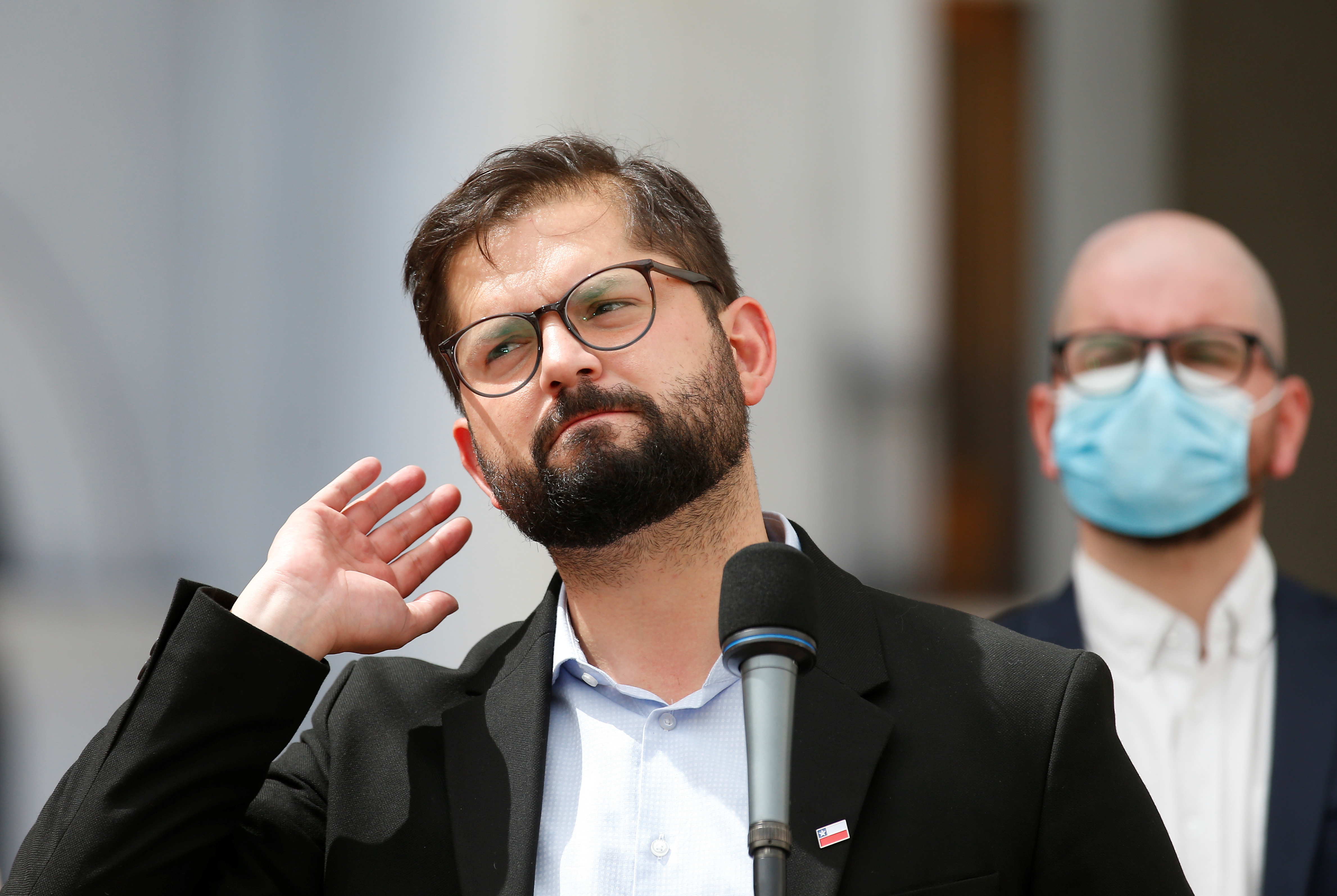 Chile's President-elect Gabriel Boric gestures as he addresses the media, at the presidential palace La Moneda, Santiago, Chile.