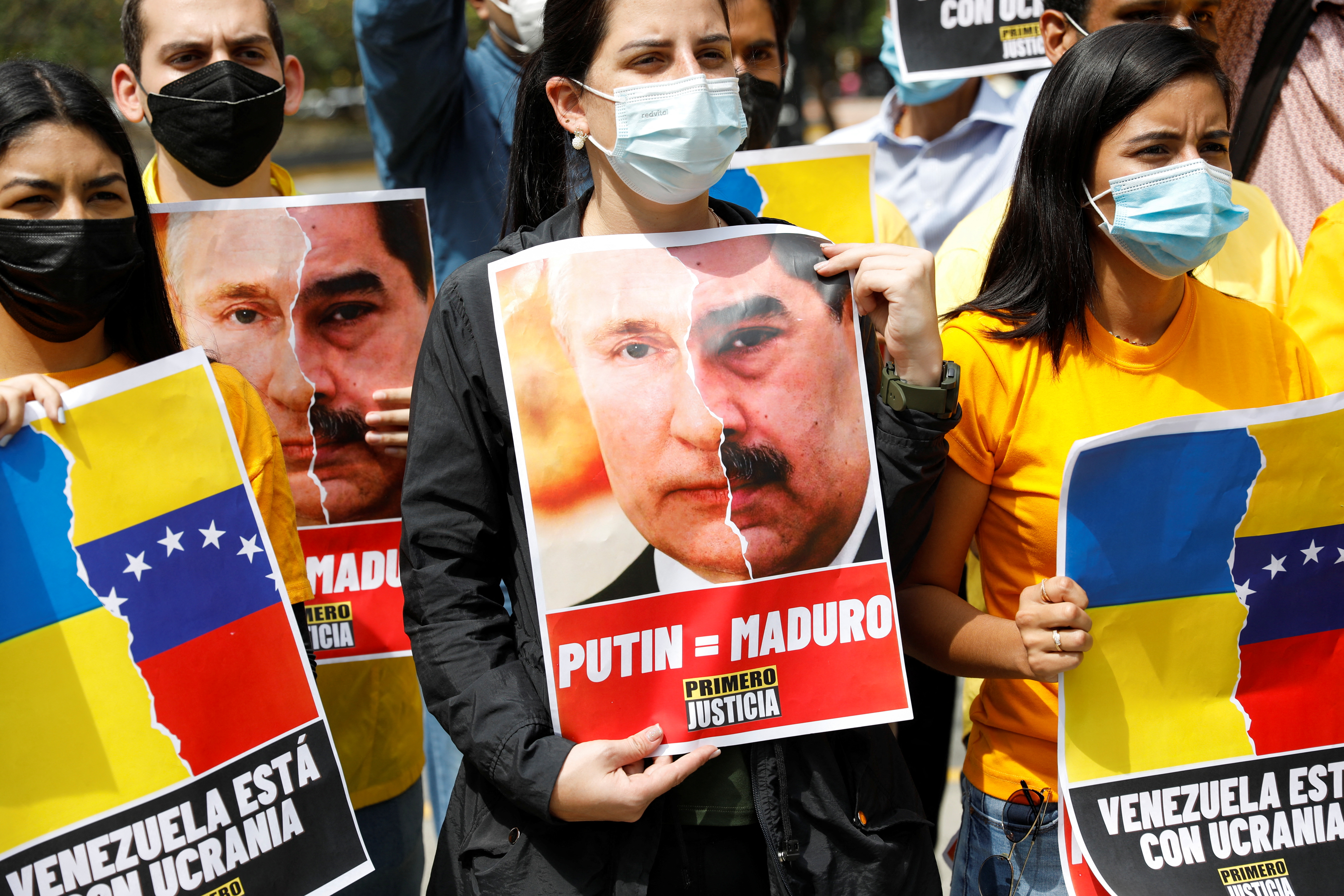 Demonstrators hold placards during an anti-war protest following Russia's invasion of Ukraine, in Caracas, Venezuela March 4, 2022.
