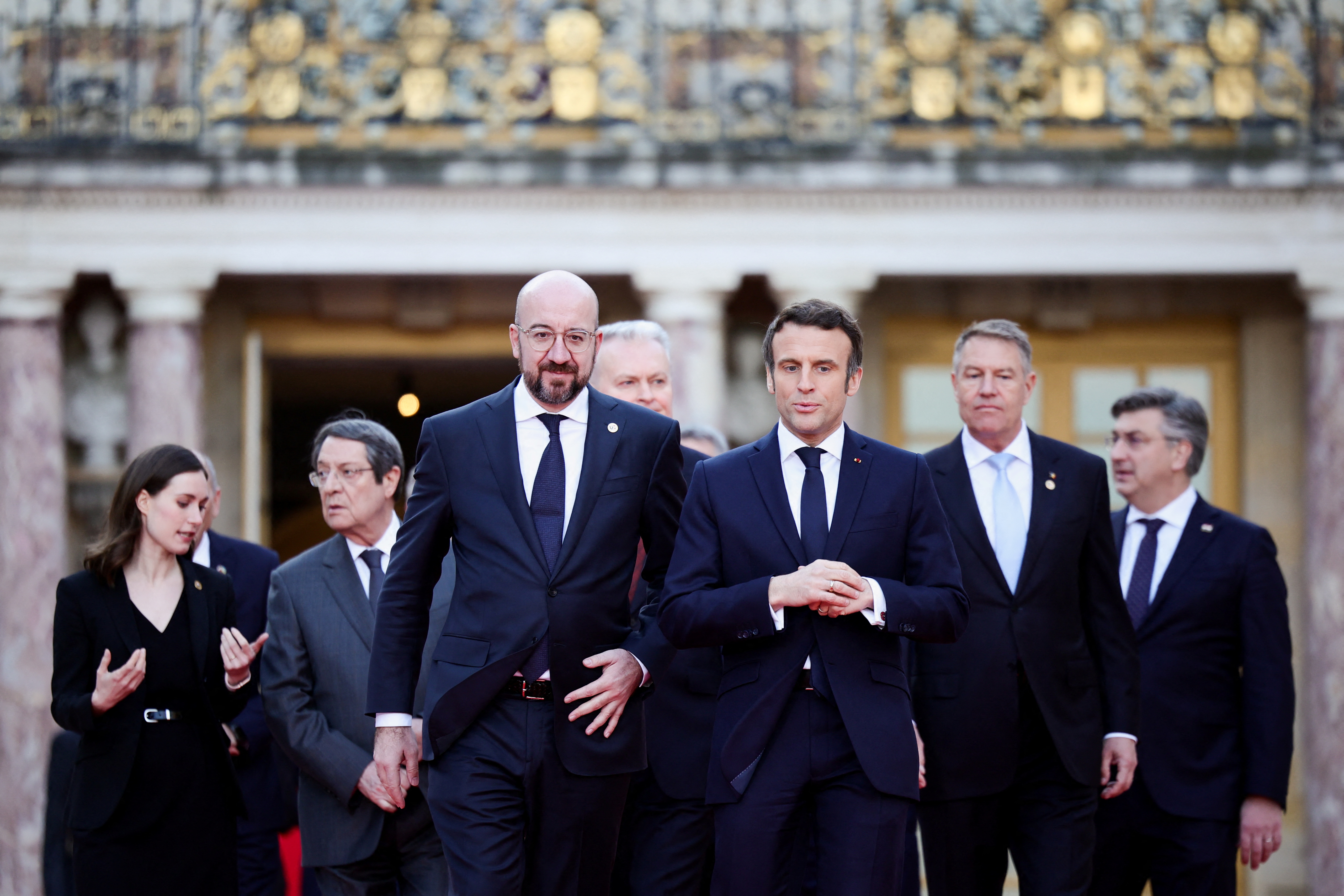 French President Emmanuel Macron, European Council President Charles Michel and EU leaders arrive for a family photo during an informal summit at the Chateau de Versailles (Versailles Palace),
