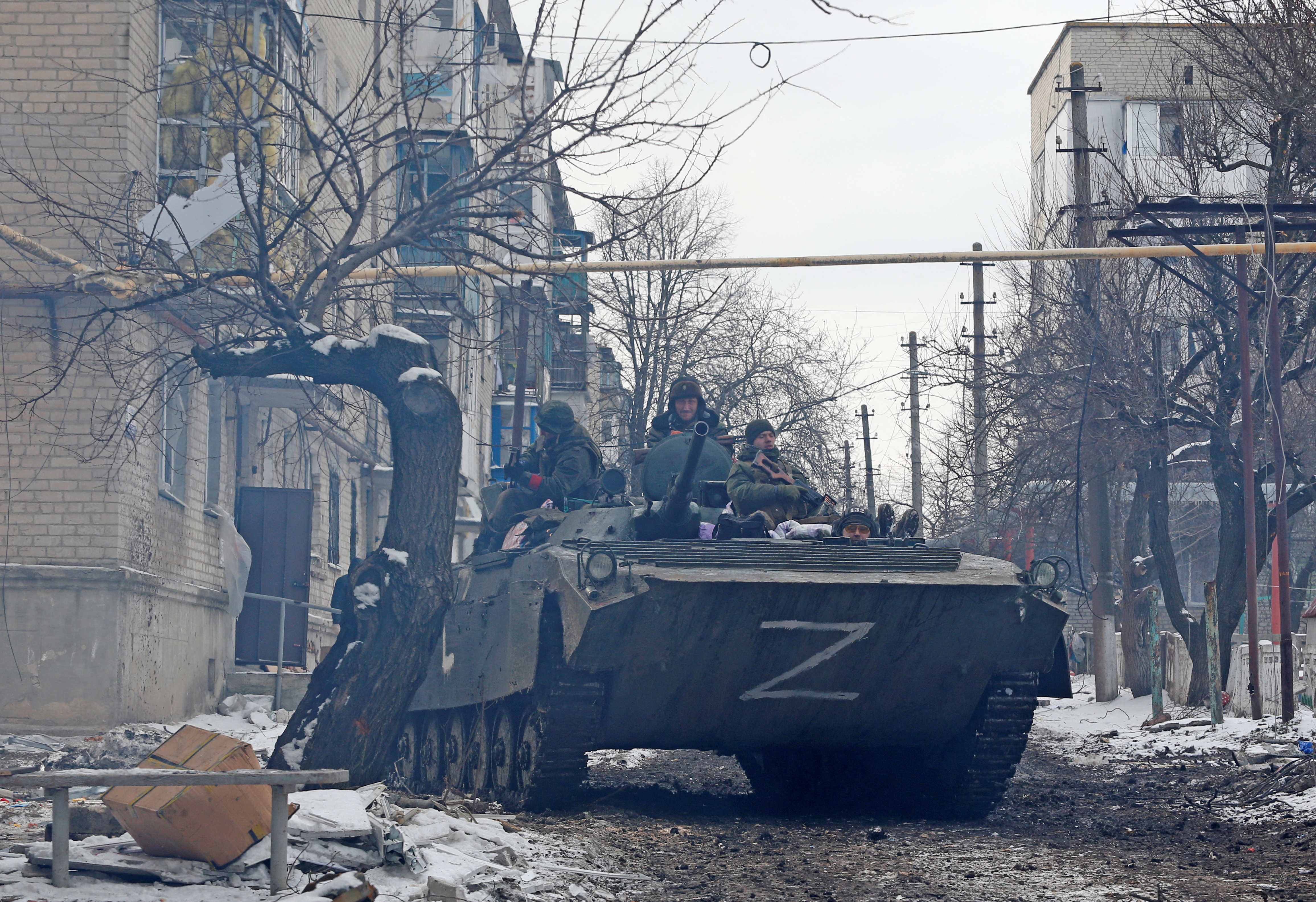 Pro-Russian troops drive an armoured vehicle with the letters "Z" painted on it in a residential area of the separatist-controlled town of Volnovakha during Ukraine-Russia conflict in the Donetsk region, Ukraine, March 11, 2022..