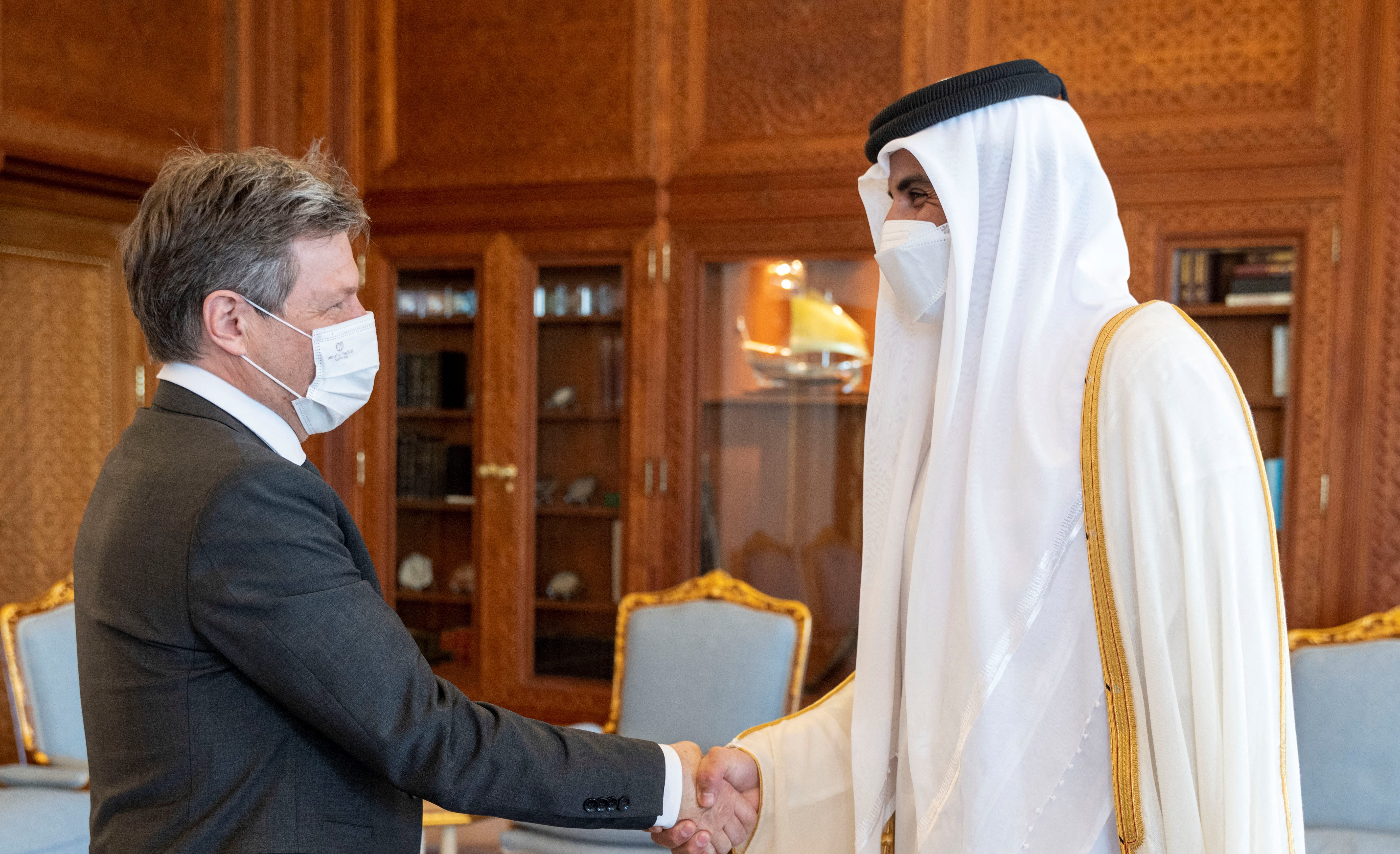 Qatari Emir Sheikh Tamim bin Hamad Al Thani shakes hands with German Economy Minister Robert Habeck, in Doha, Qatar