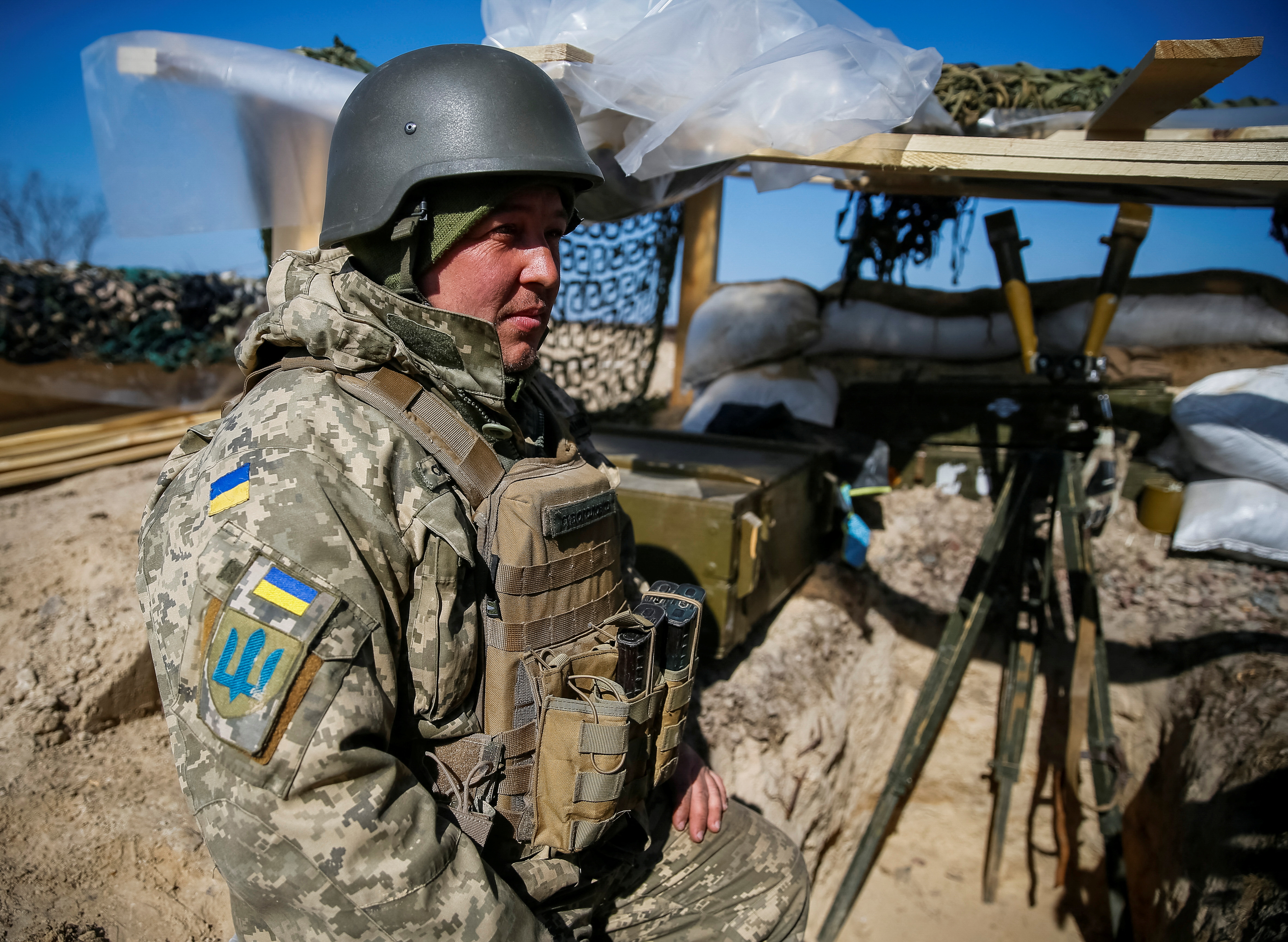 A Ukrainian service member stands at a position on the front line in the east Kyiv region.