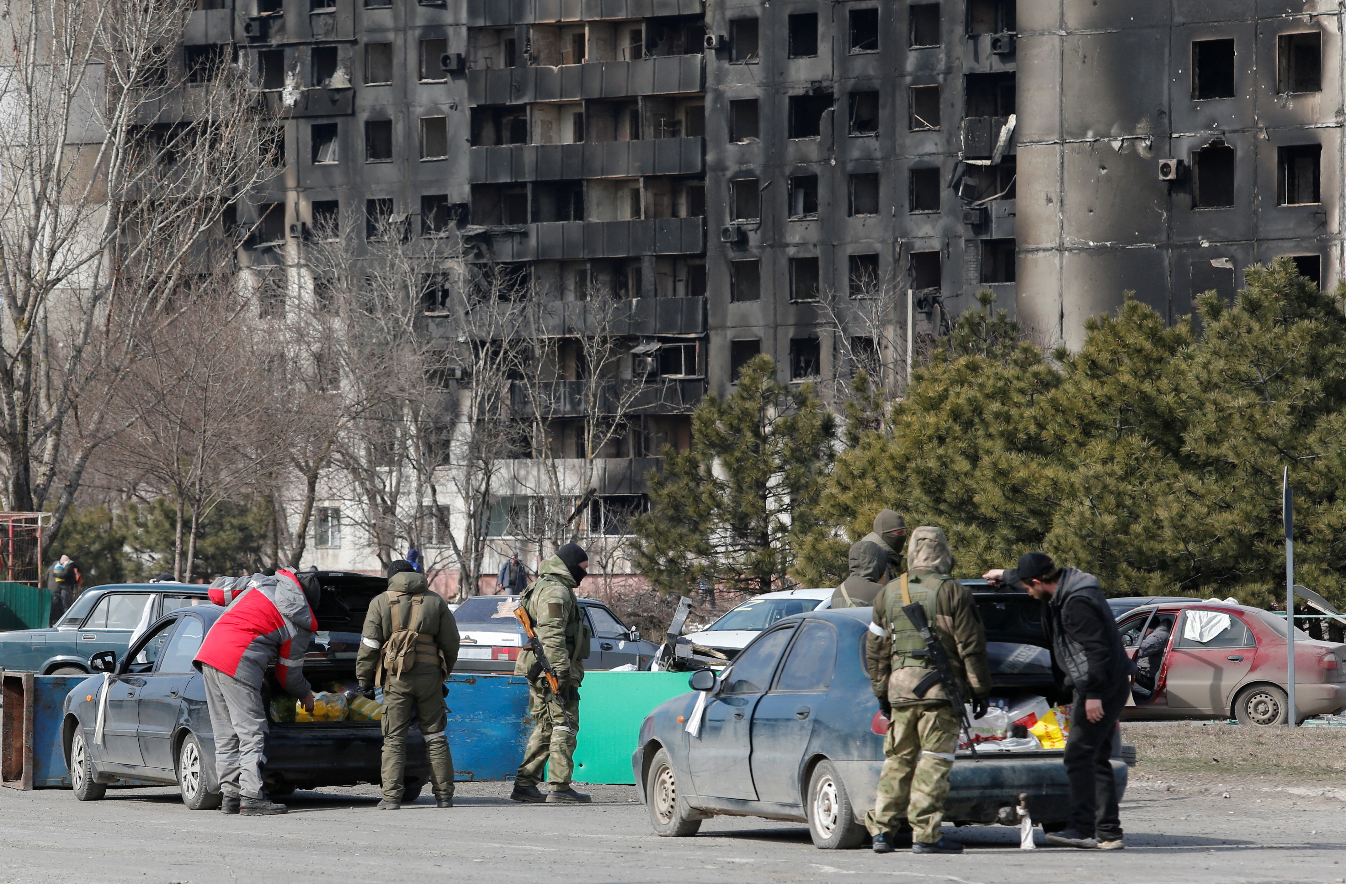 Service members of pro-Russian troops check cars during Ukraine-Russia conflict in the besieged southern port city of Mariupol