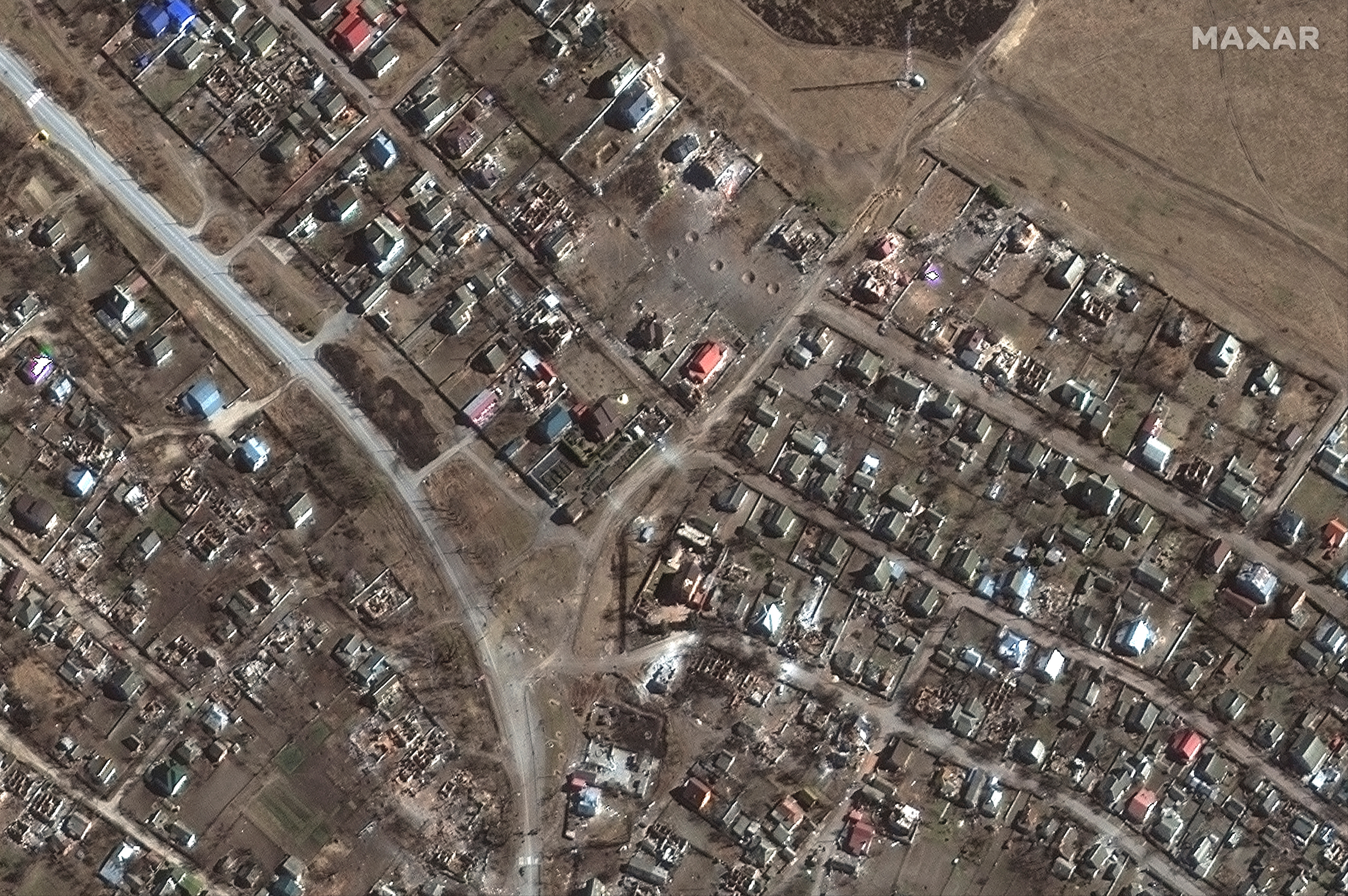 A satellite image shows large craters and destoyed homes in Novoselivka, Ukraine, March 21, 2022