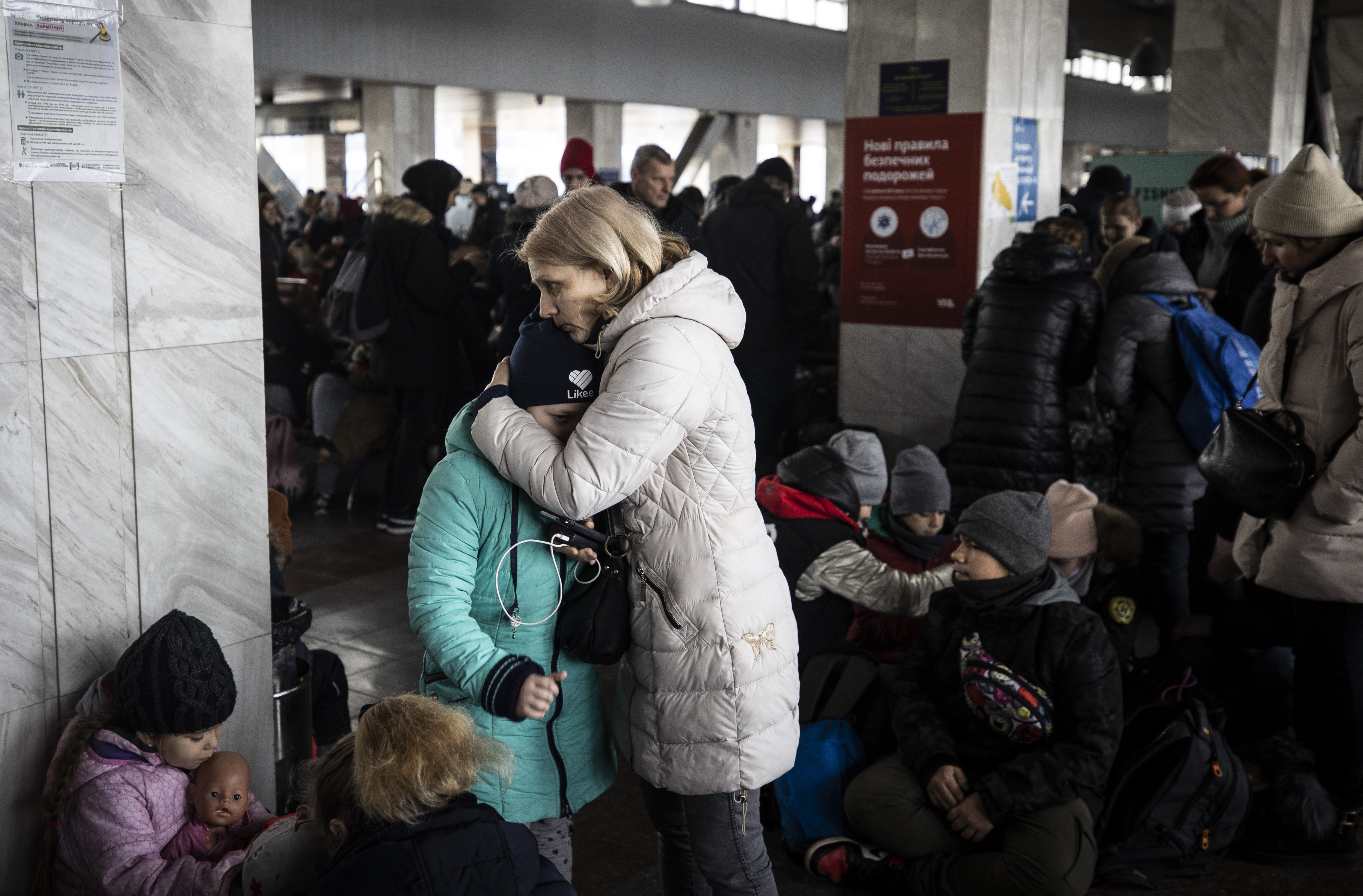 Kyiv residents flock to a train station to flee the city.