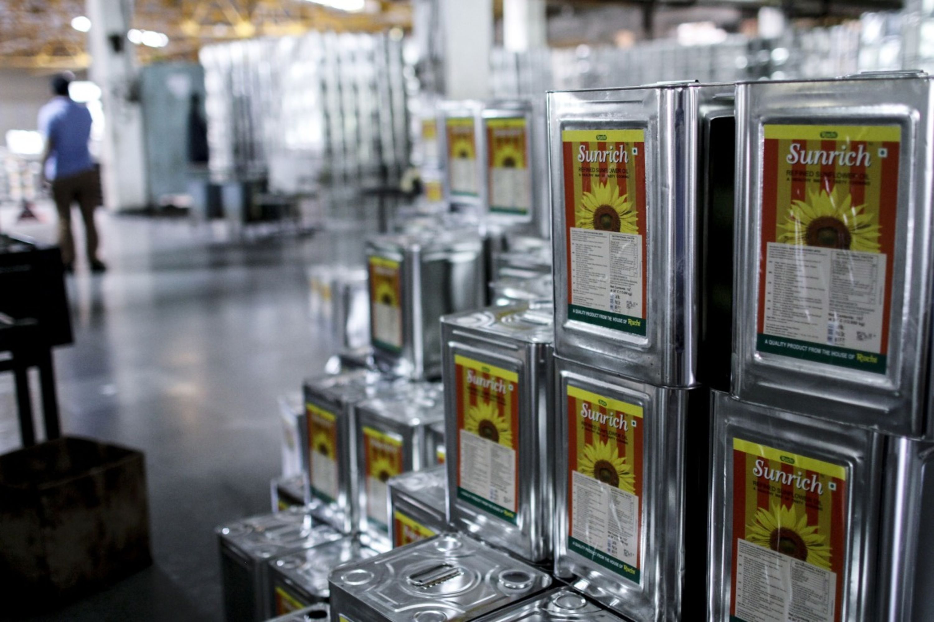 Stacks of 15-liter tins of refined sunflower oil at a refinery in India