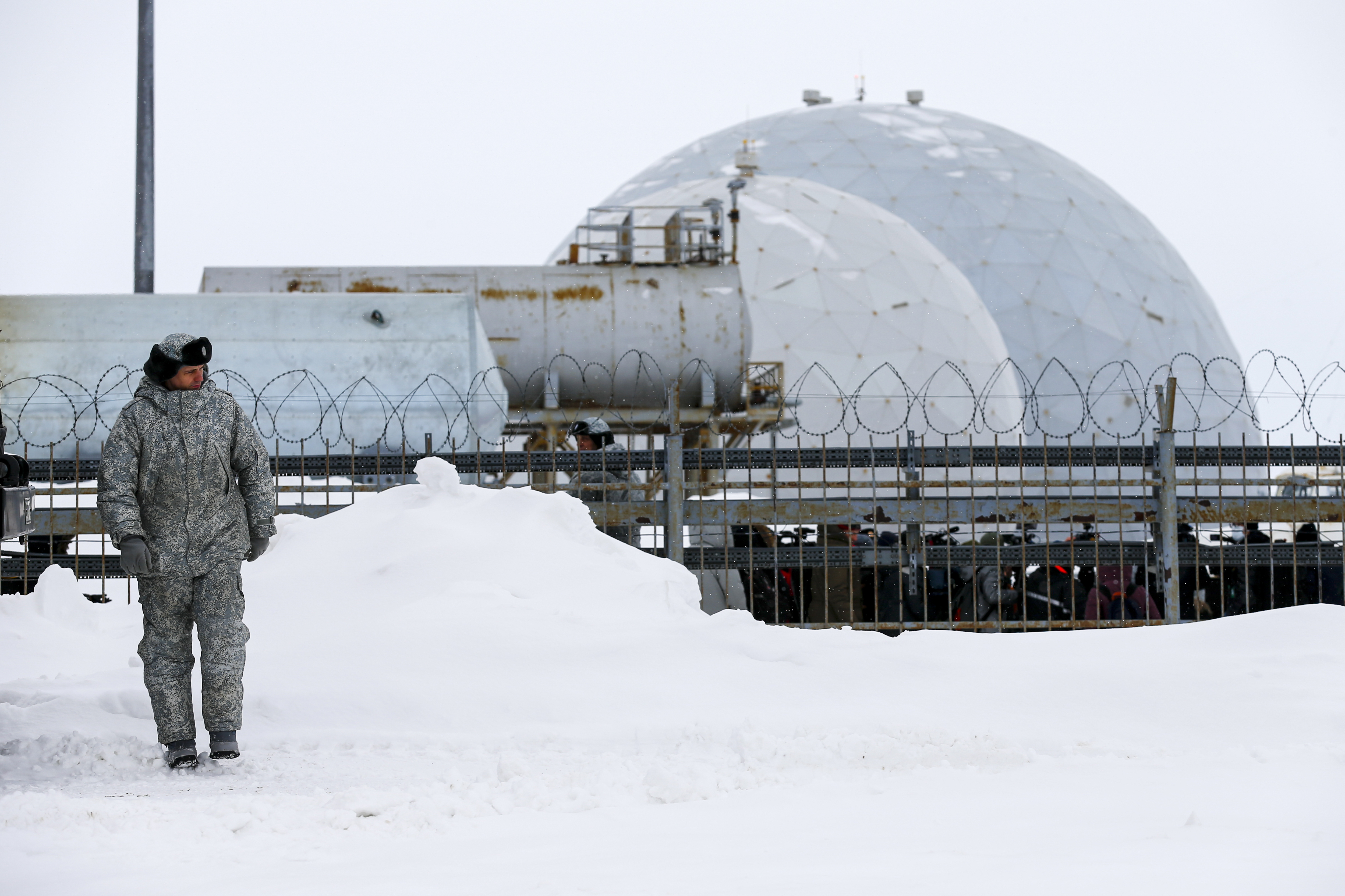 A soldier walks at a radar facility on the Alexandra Land island near Nagurskoye, Russia, Monday, May 17, 2021. Once a desolate home mostly to polar bears, Russia's northernmost military outpost is bristling with missiles and radar and its extended runway can handle all types of aircraft, including nuclear-capable strategic bombers, projecting Moscow's power and influence across the Arctic amid intensifying international competition for the region's vast resources