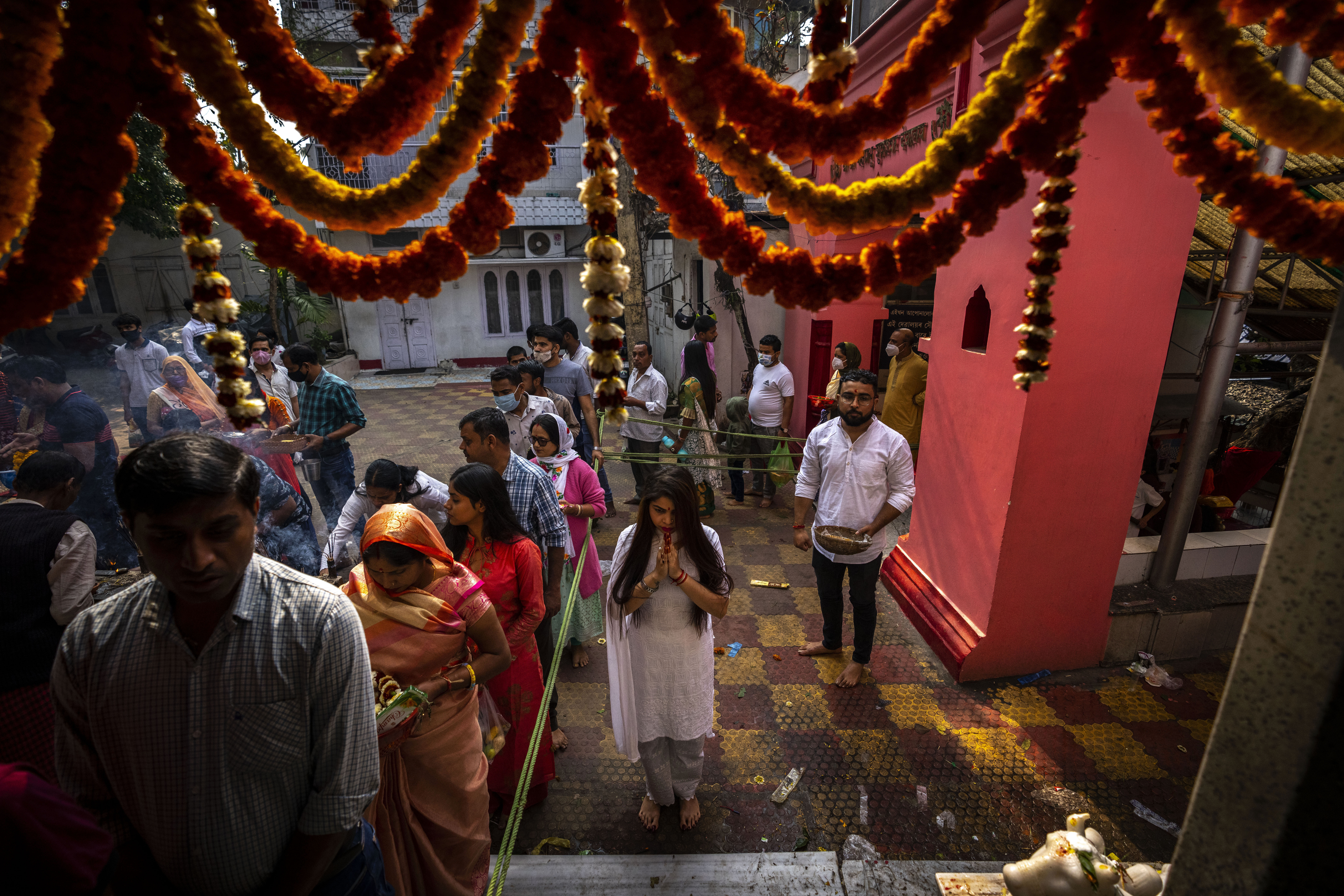 Hindu devotees queue up to worship at a temple of Hindu god Shiva during Shivratri festival, in Gauhati, India