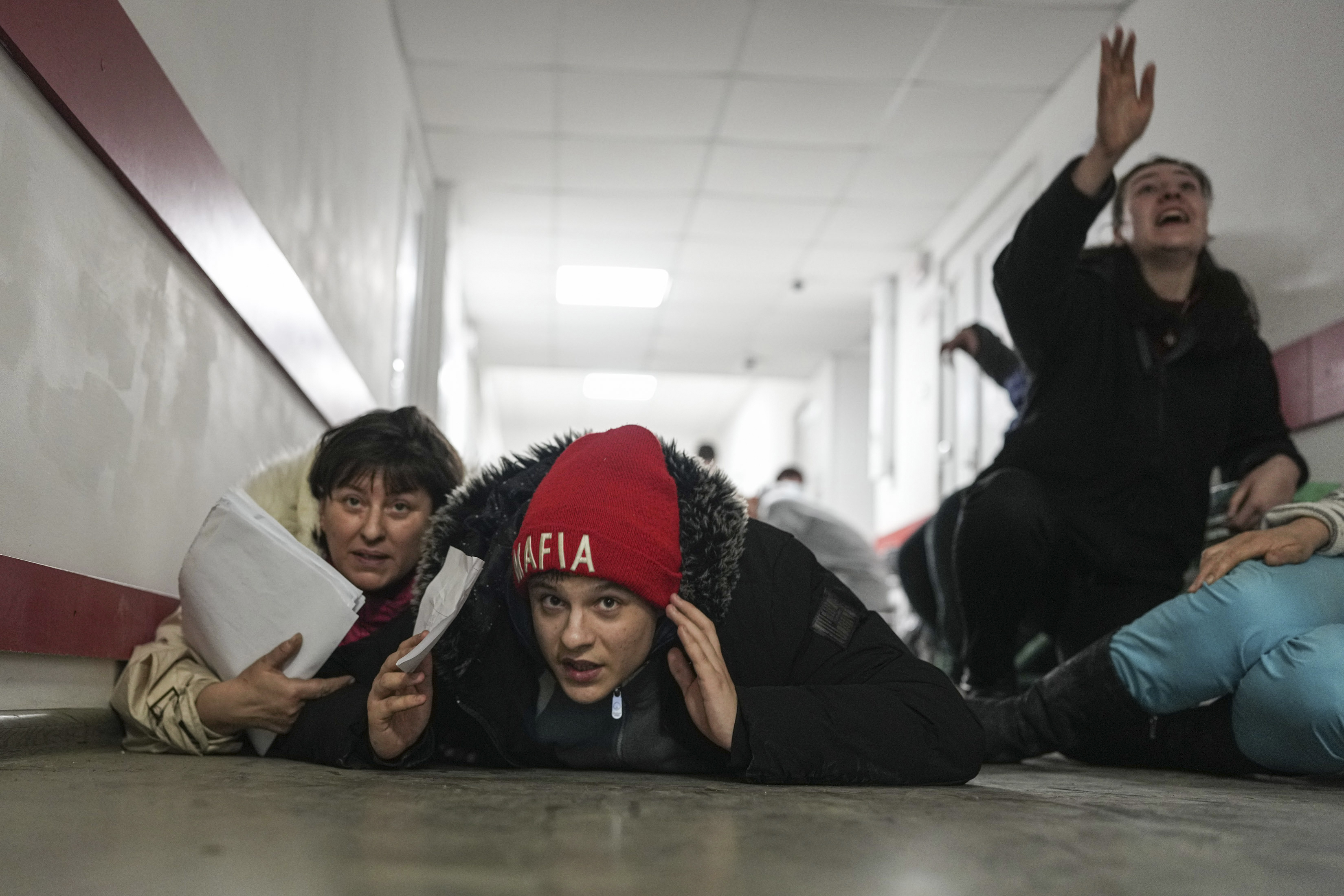 People lie on the floor of a hospital during shelling by Russian forces in Mariupol