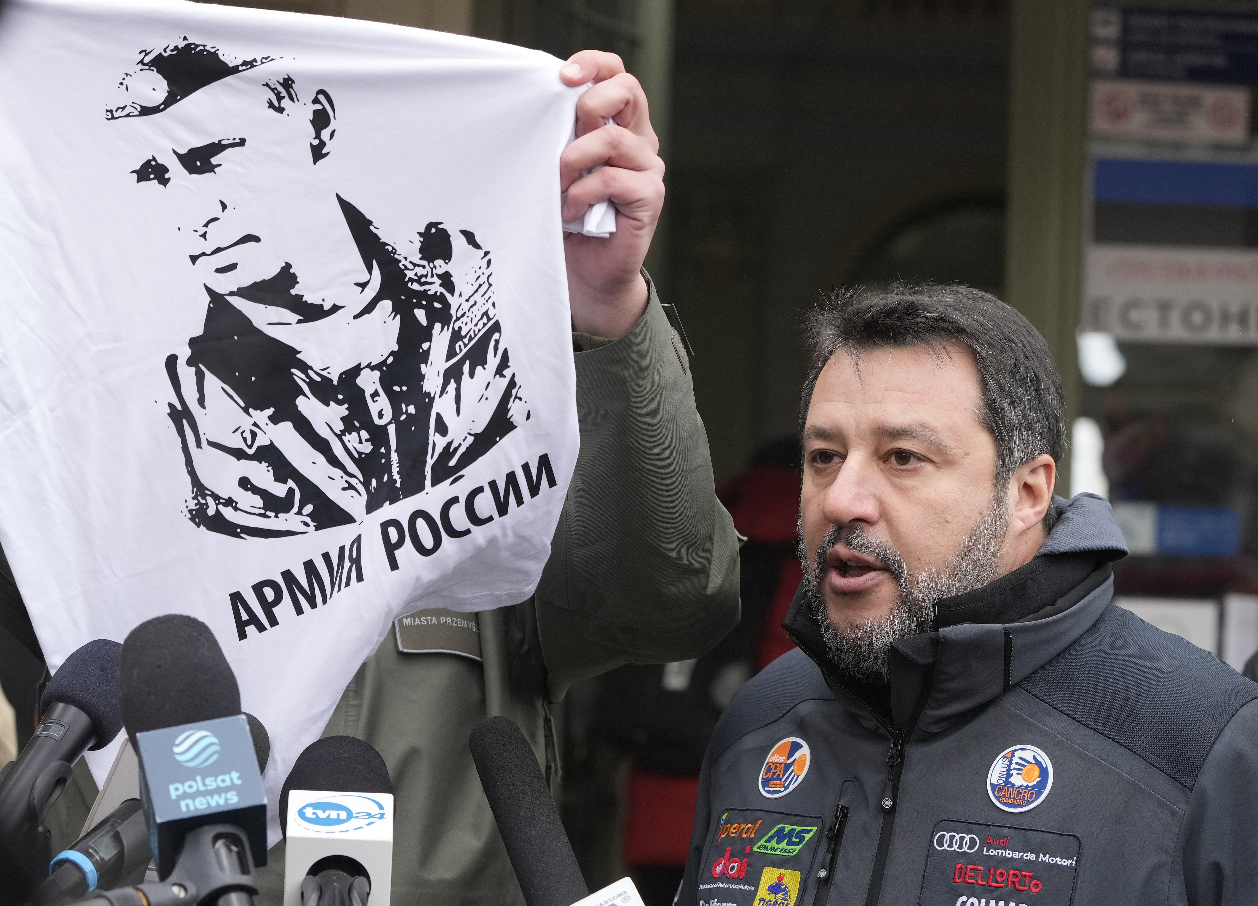 The Mayor of Przemysl, Wojciech Bakun, left, holds up a t-shirt with the likeness of Russian President Vladimir Putin and the words "The Russian Army" as Italy's League Party leader