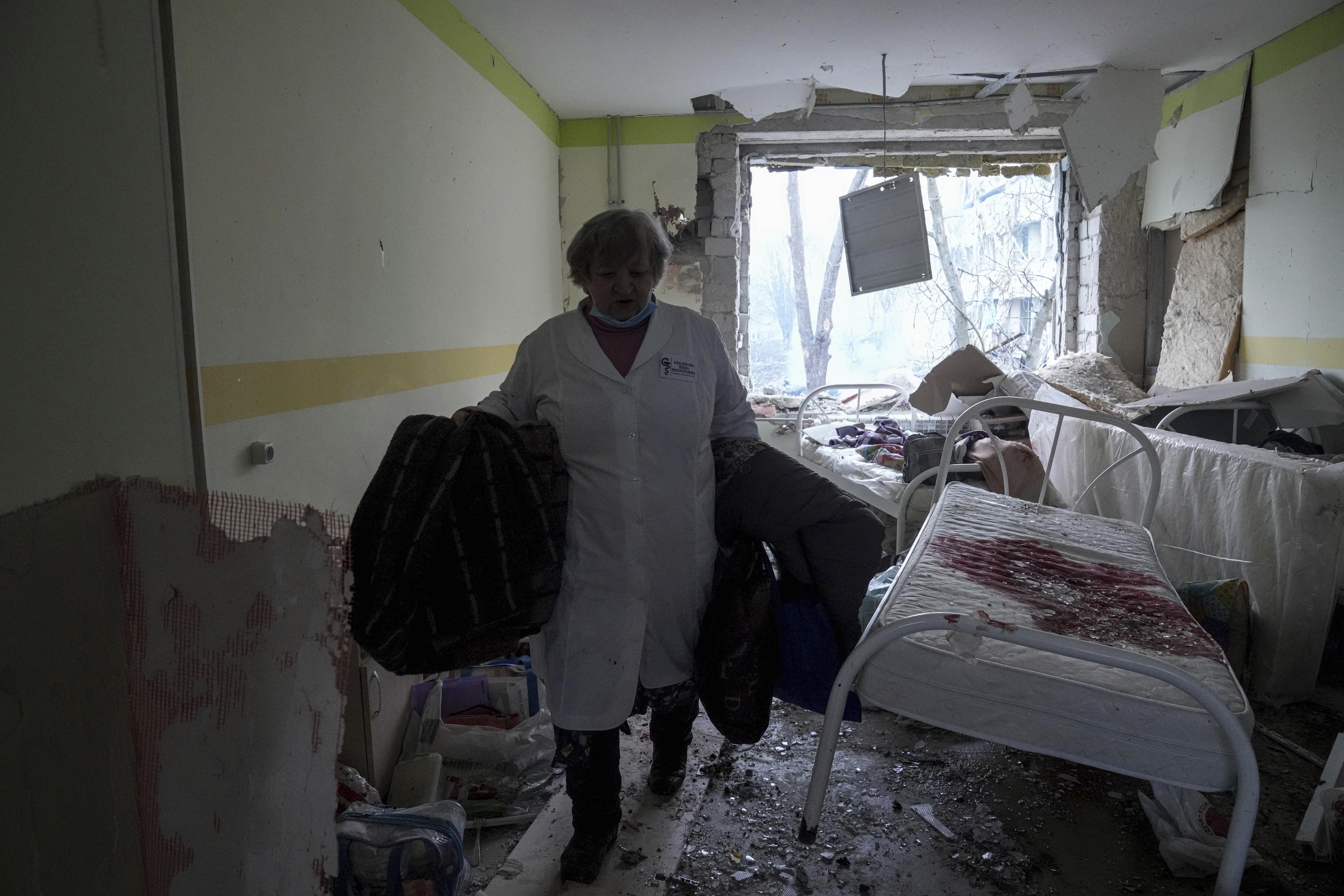 A medical worker walks inside the maternity hospital damaged by shelling in Mariupol, Ukraine.