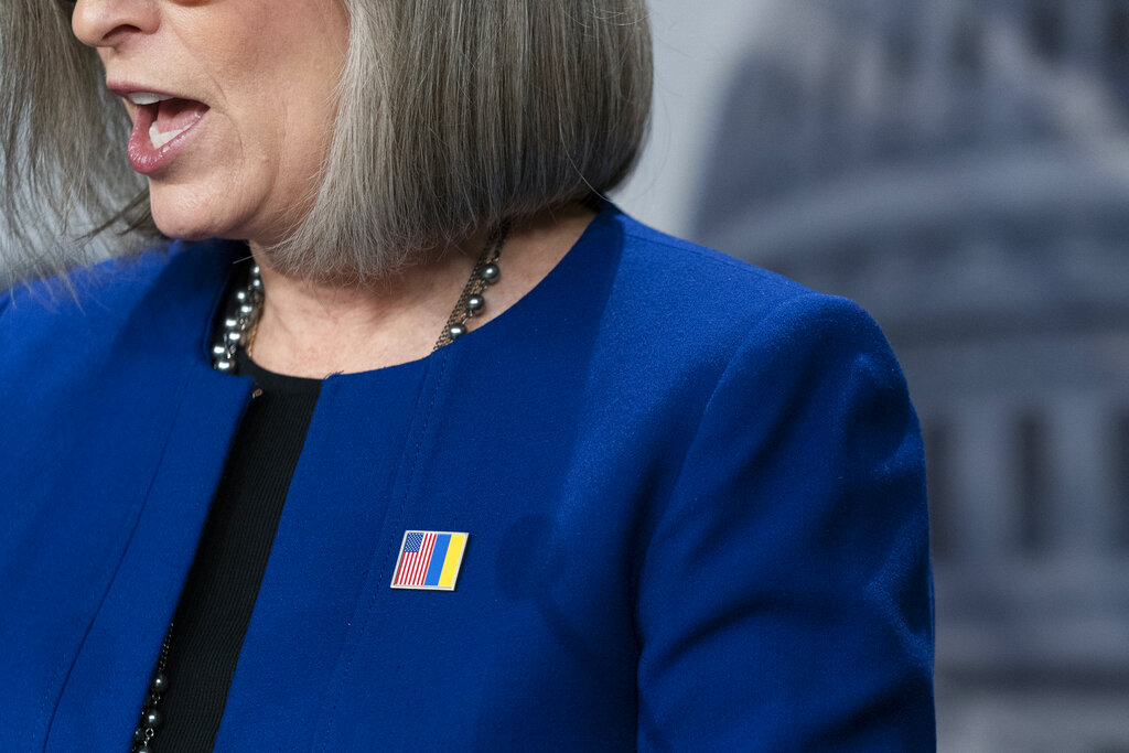 Republican Senator Joni Ernst wears a pin pairing the American red white and blue flag with the Ukrainian blue and yellow to showoff the embattled Eastern European nation.