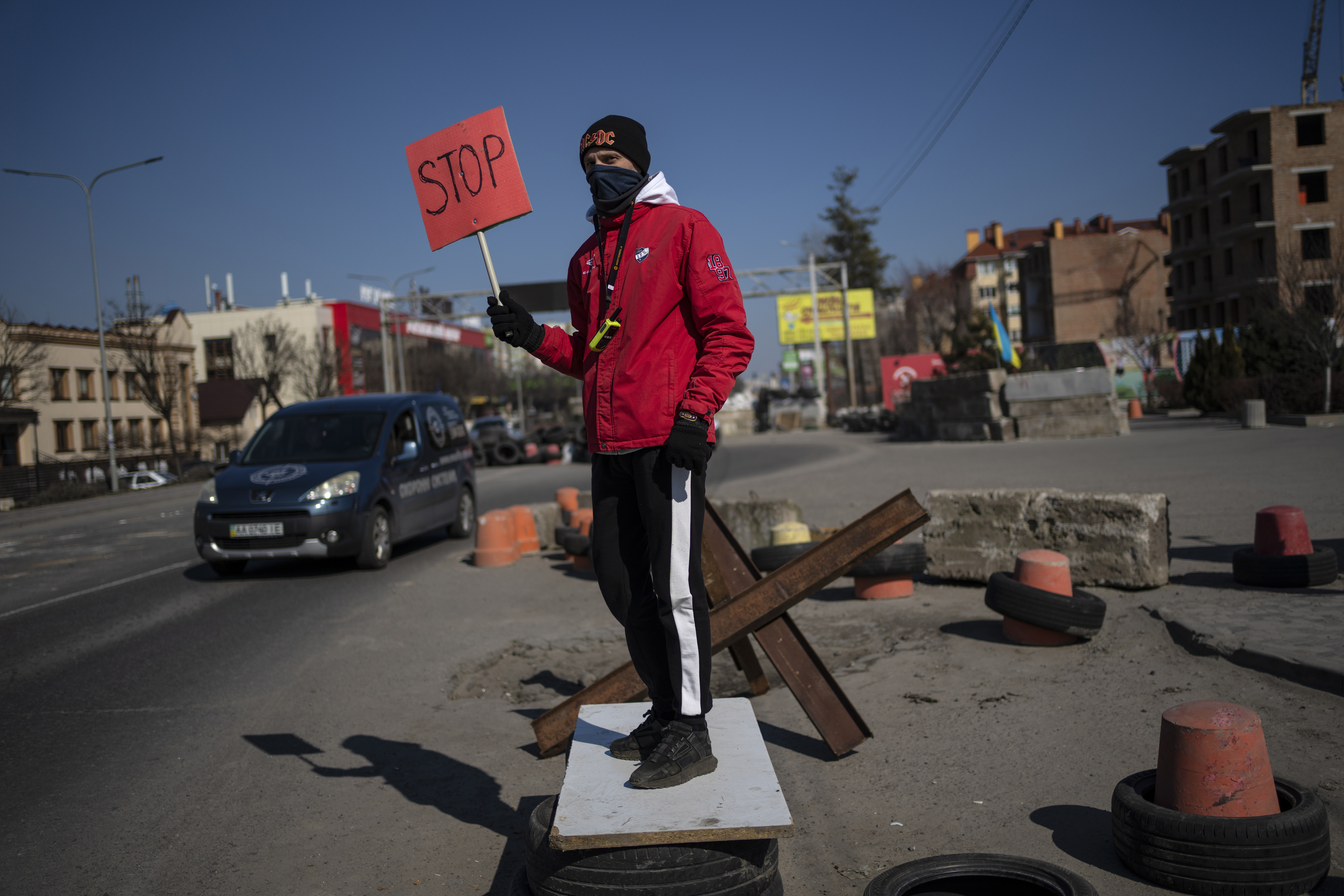 A neighbor works as a traffic officer at one of the barricades built by territorial defense units in the outskirts of Kyiv