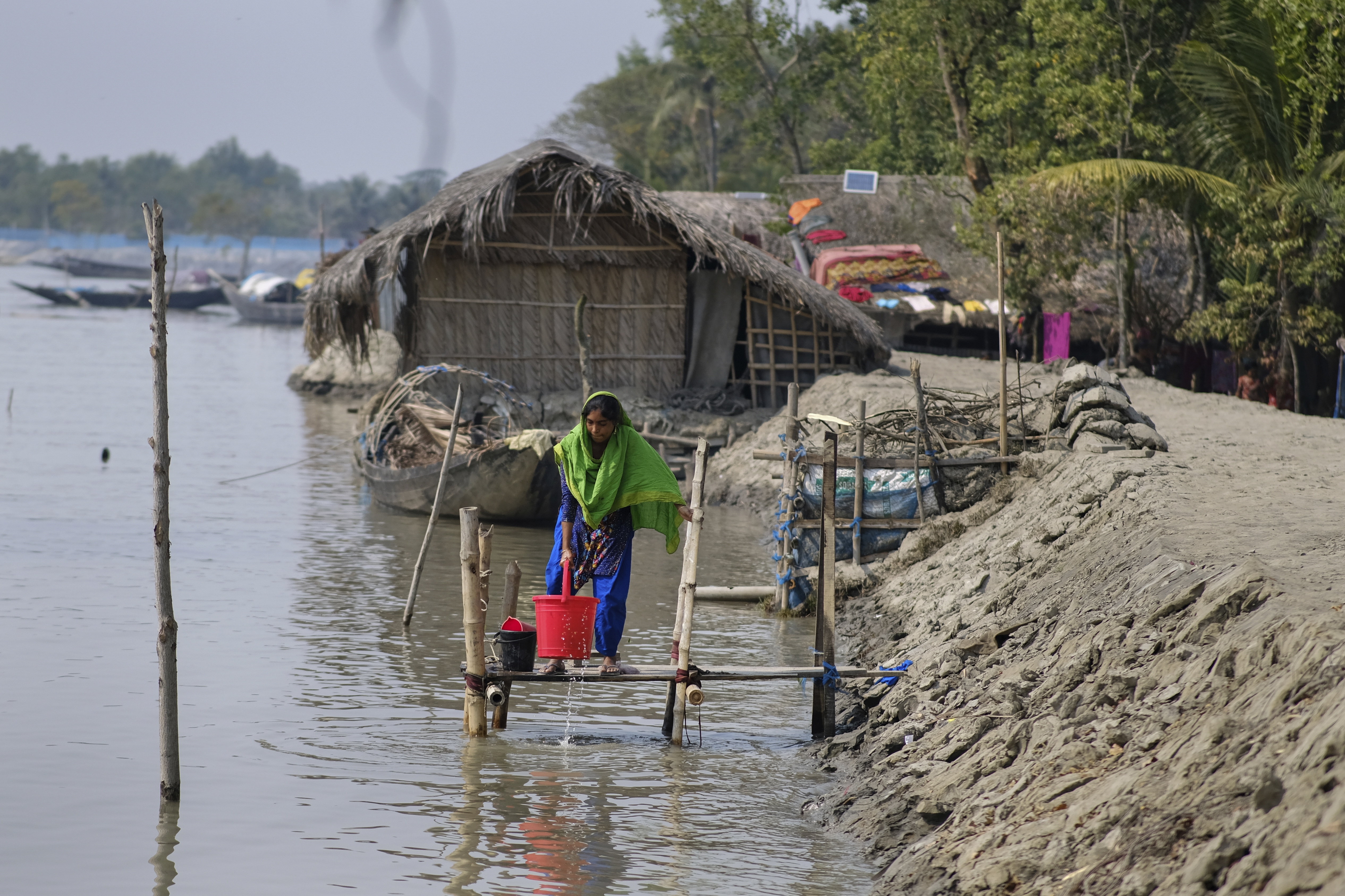 Reshma Begum, 28, collects water from the Pasur River in Mongla