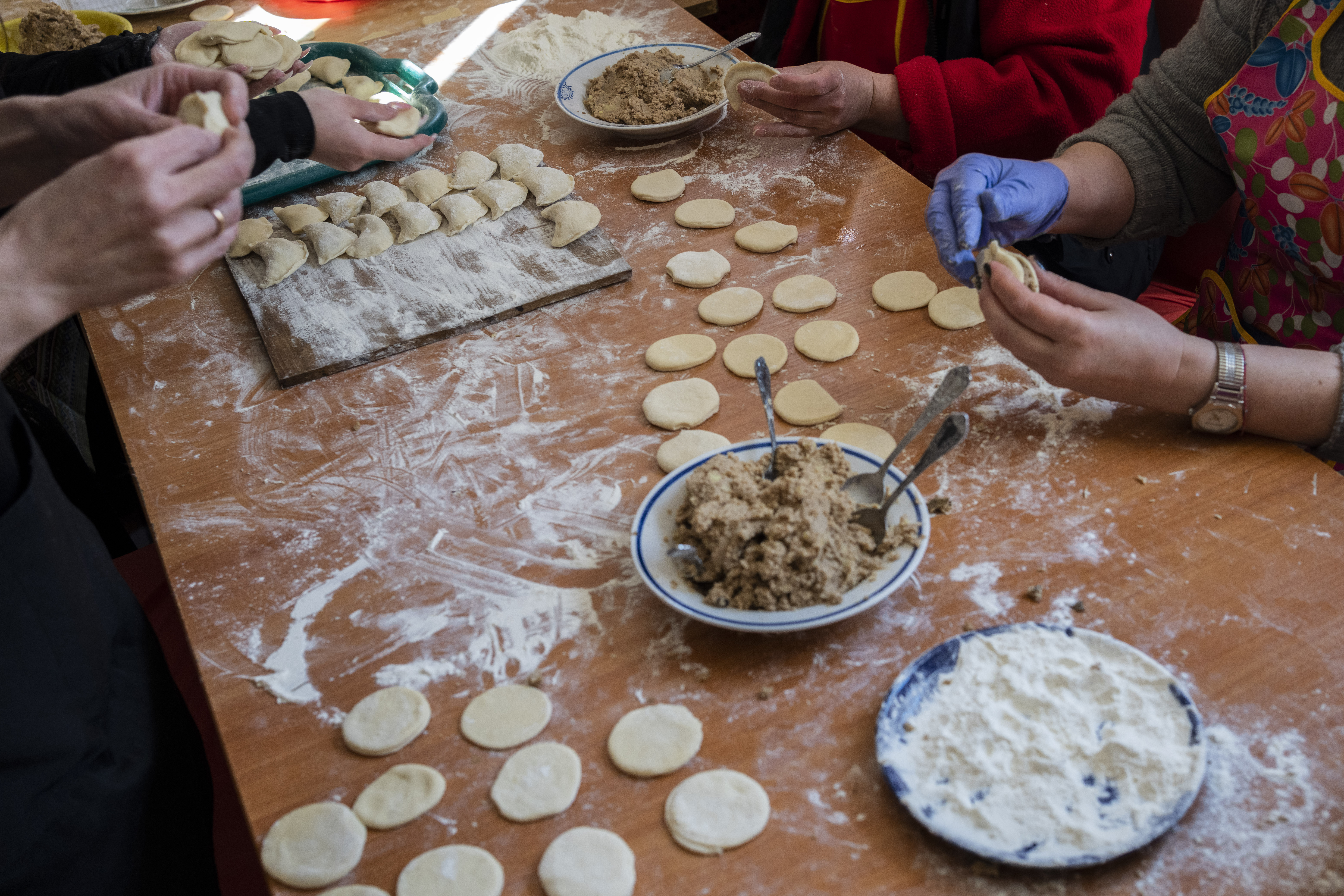 Volunteers prepare varenyky, stuffed dumplings, inside a theatre in the city of Drohobych