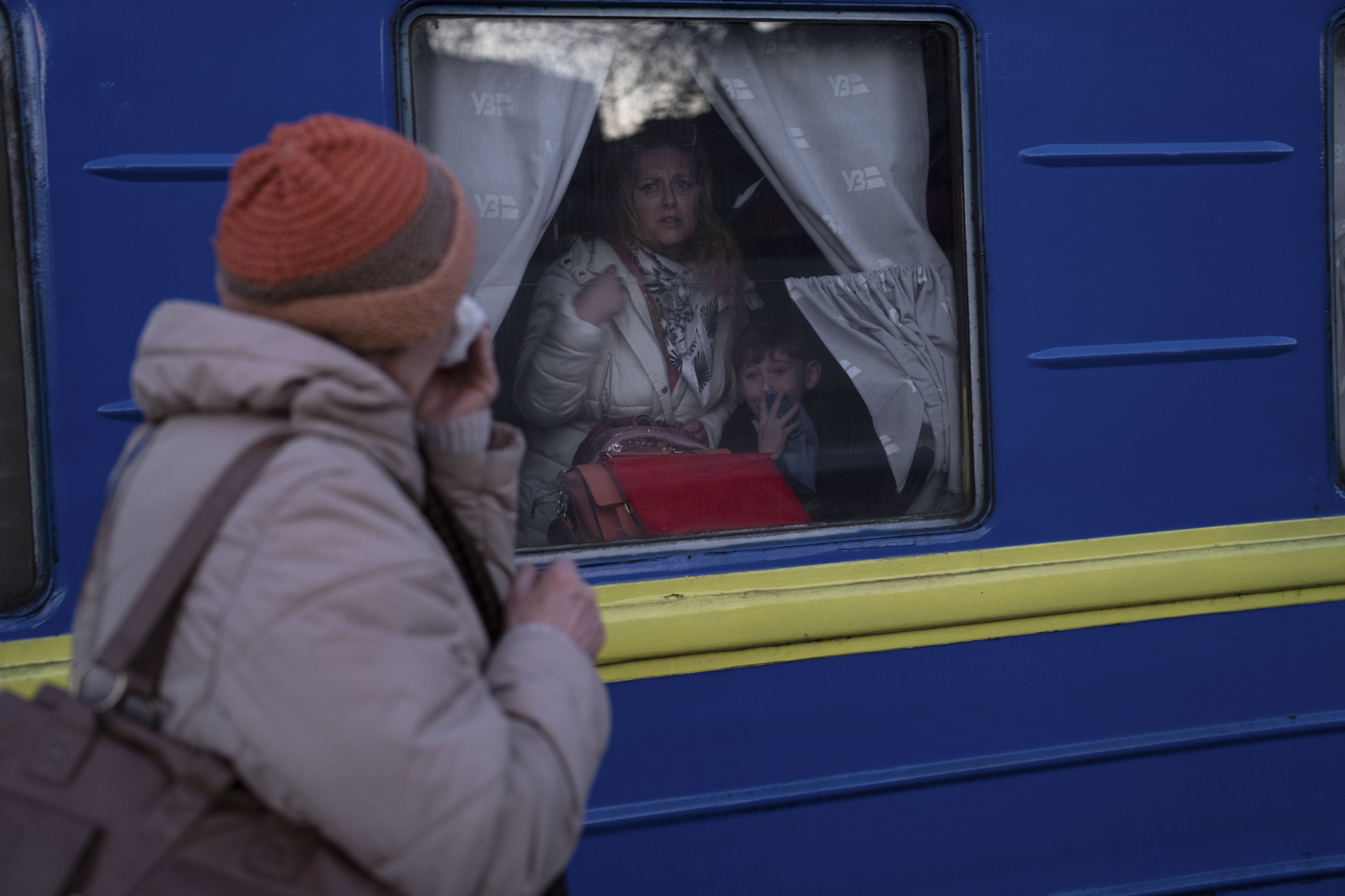 Ludmila, left, says goodbye to her granddaughter Kristina, who with her son Yaric, leave the train station in Odesa