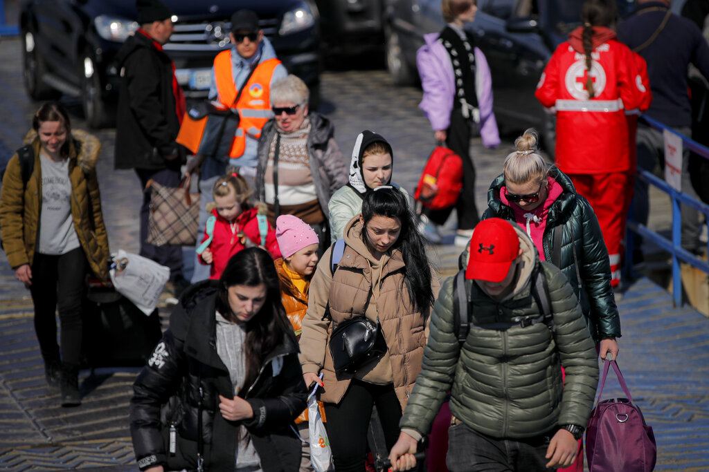 Refugees fleeing the war from neighbouring Ukraine walk after crossing the border by ferry at the Isaccea-Orlivka border crossing in Romania.