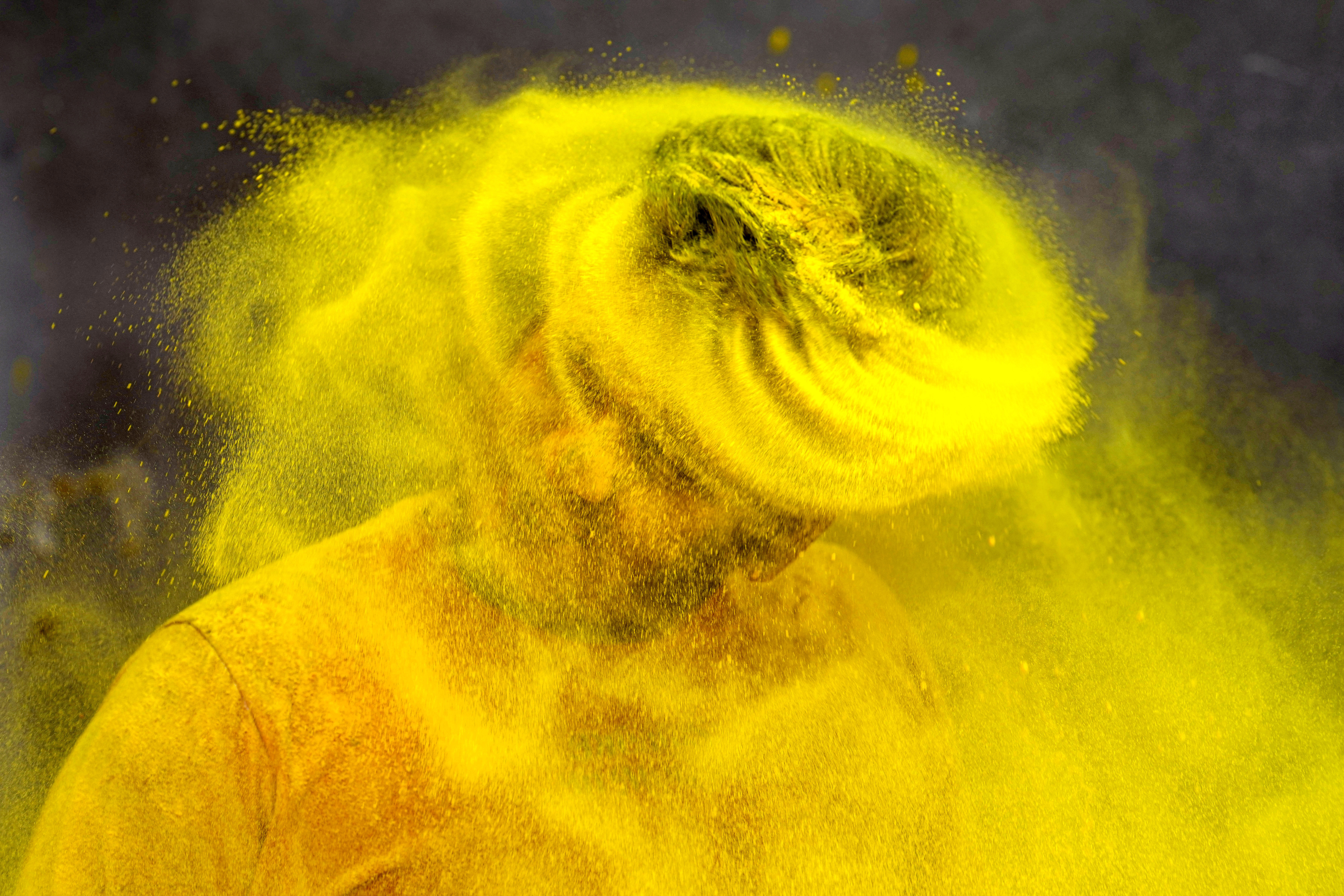 A trainer at a gymnasium plays Holi, the Hindu festival of colors, in Prayagraj, in the northern Indian state of Uttar Pradesh