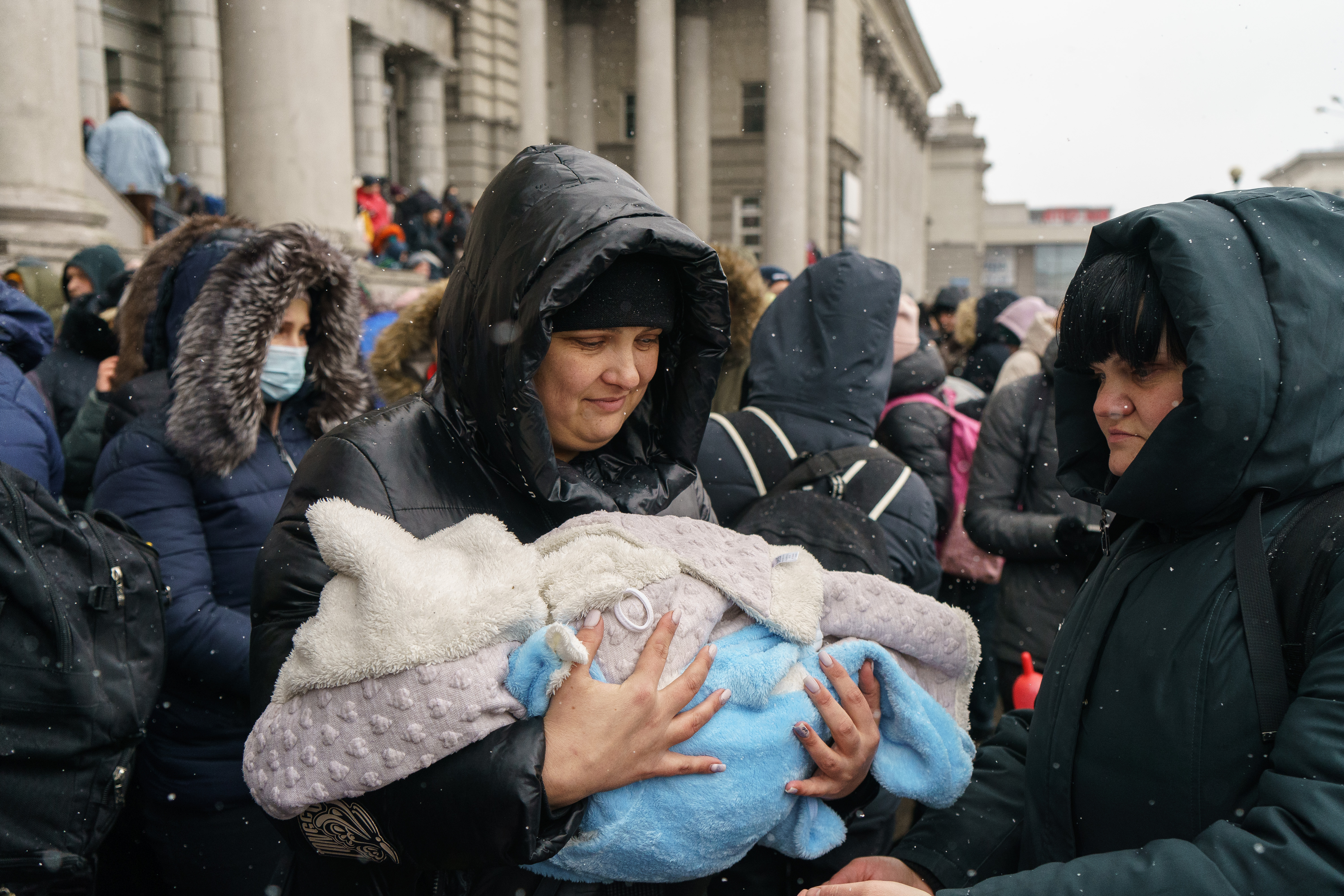 People try to get an evacuation train at Dnipro train station
