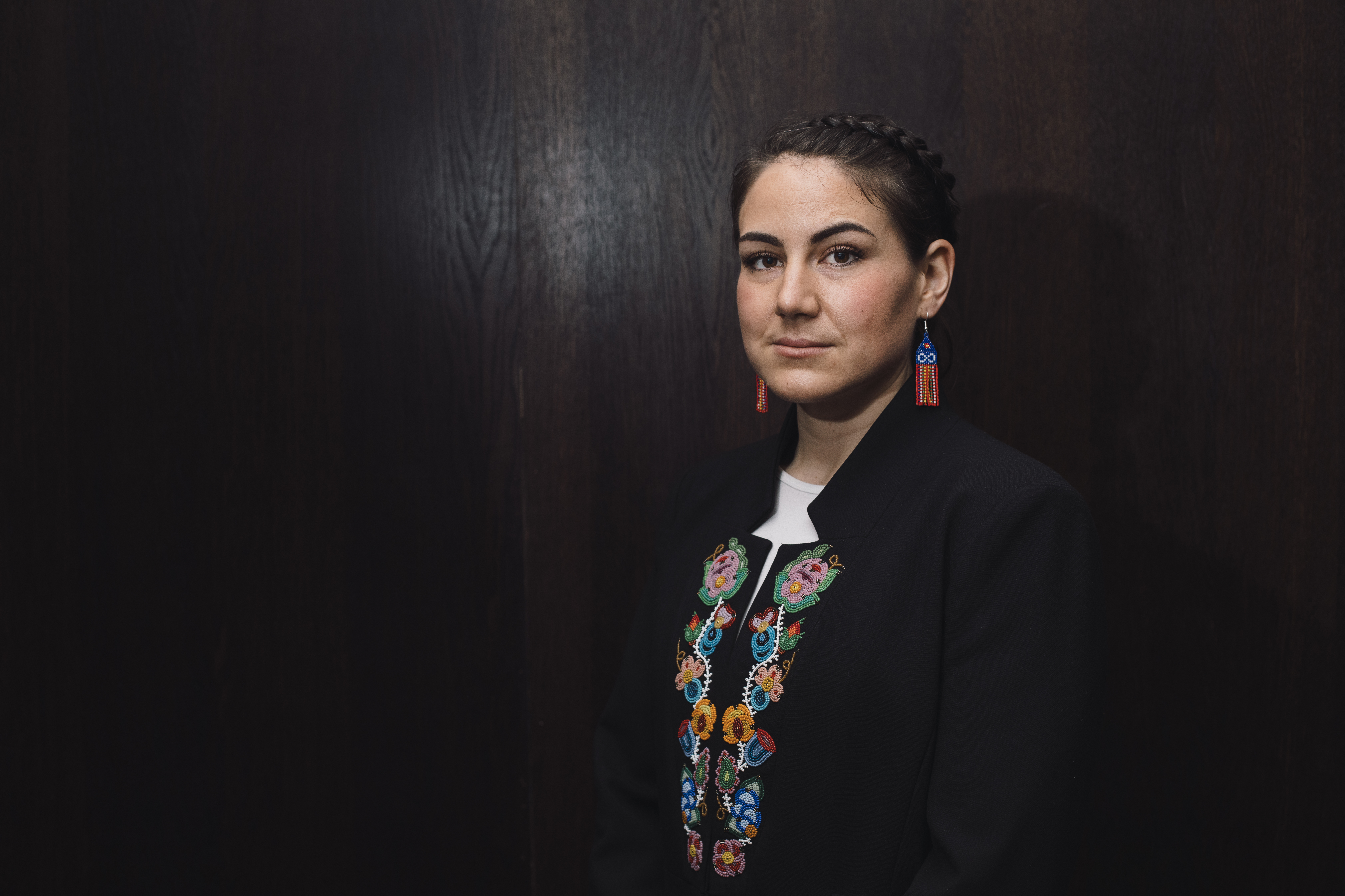 A photo of Cassidy Caron, Metis National council president, wearing a beaded jacket.