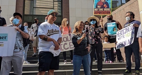 A photo of Ny Nourn, right, next to Nate, left, at a rally in Los Angeles.