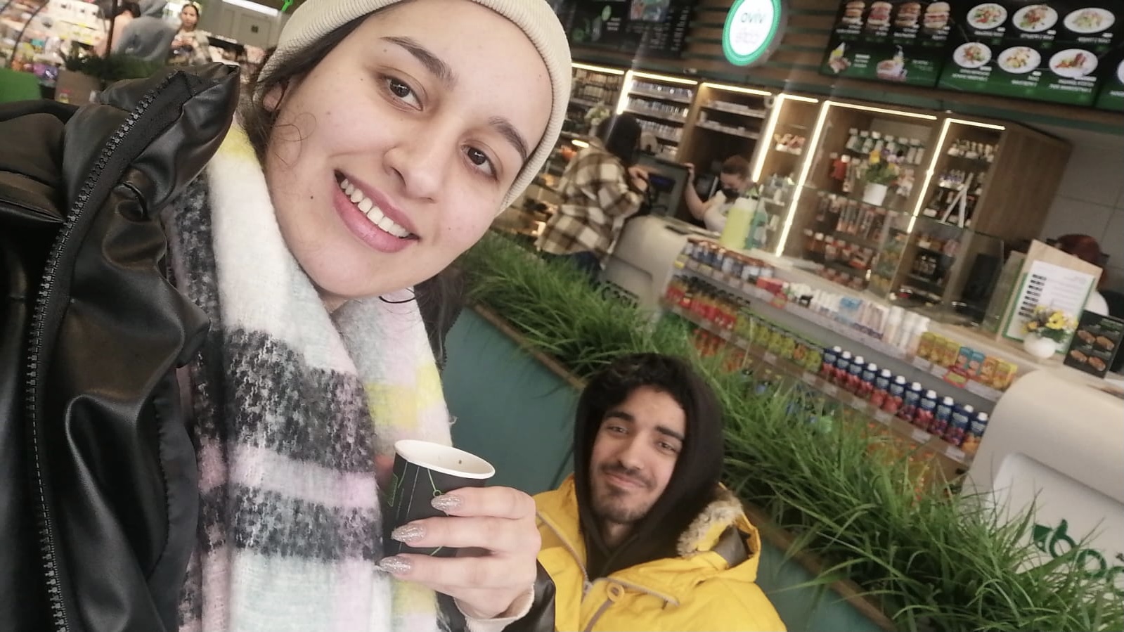 A man and woman holding coffee cups.