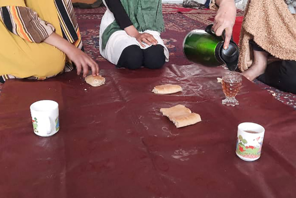 Family sits to eat bread