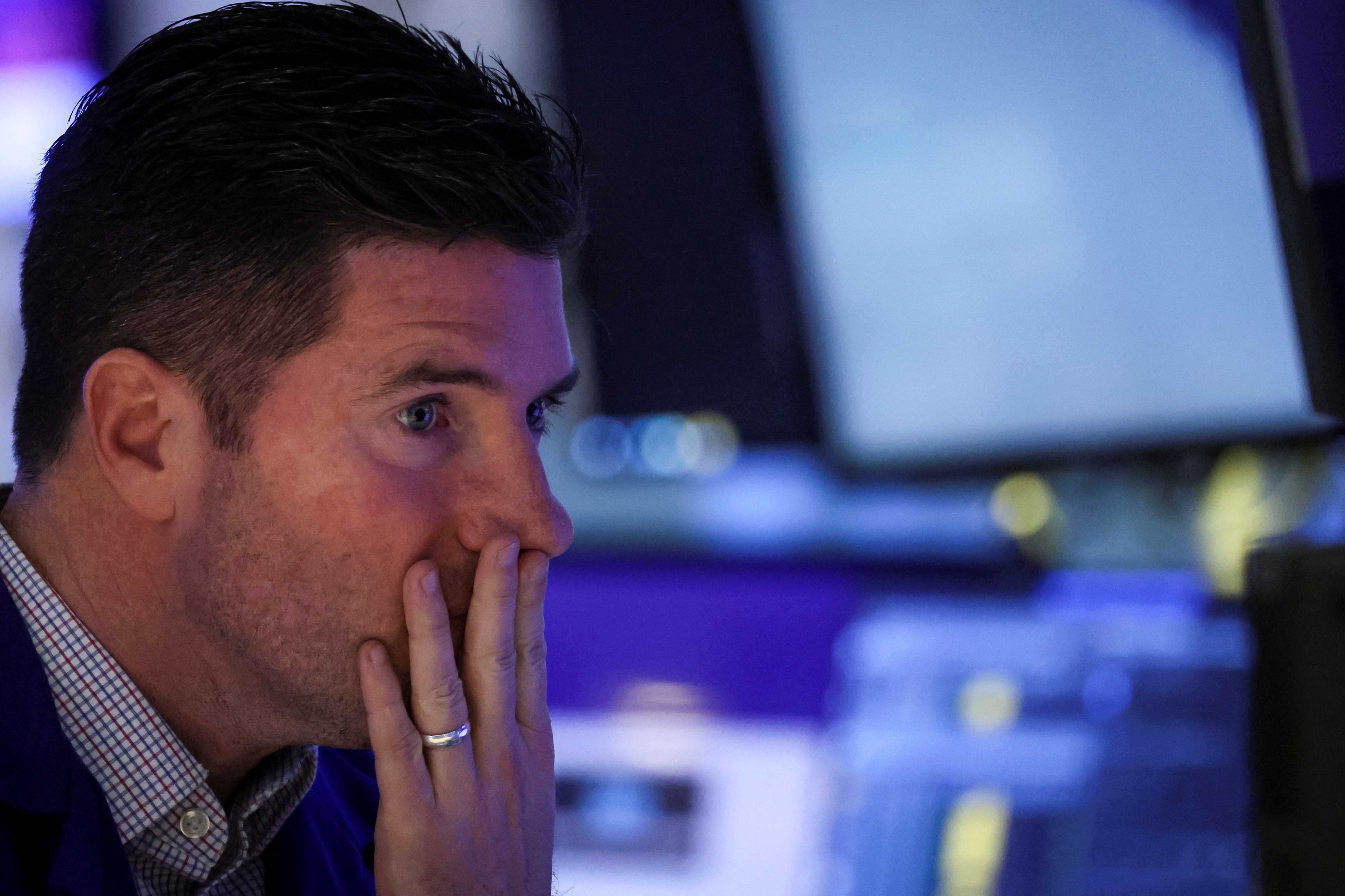 A specialist trader works inside a post on the floor of the New York Stock Exchange