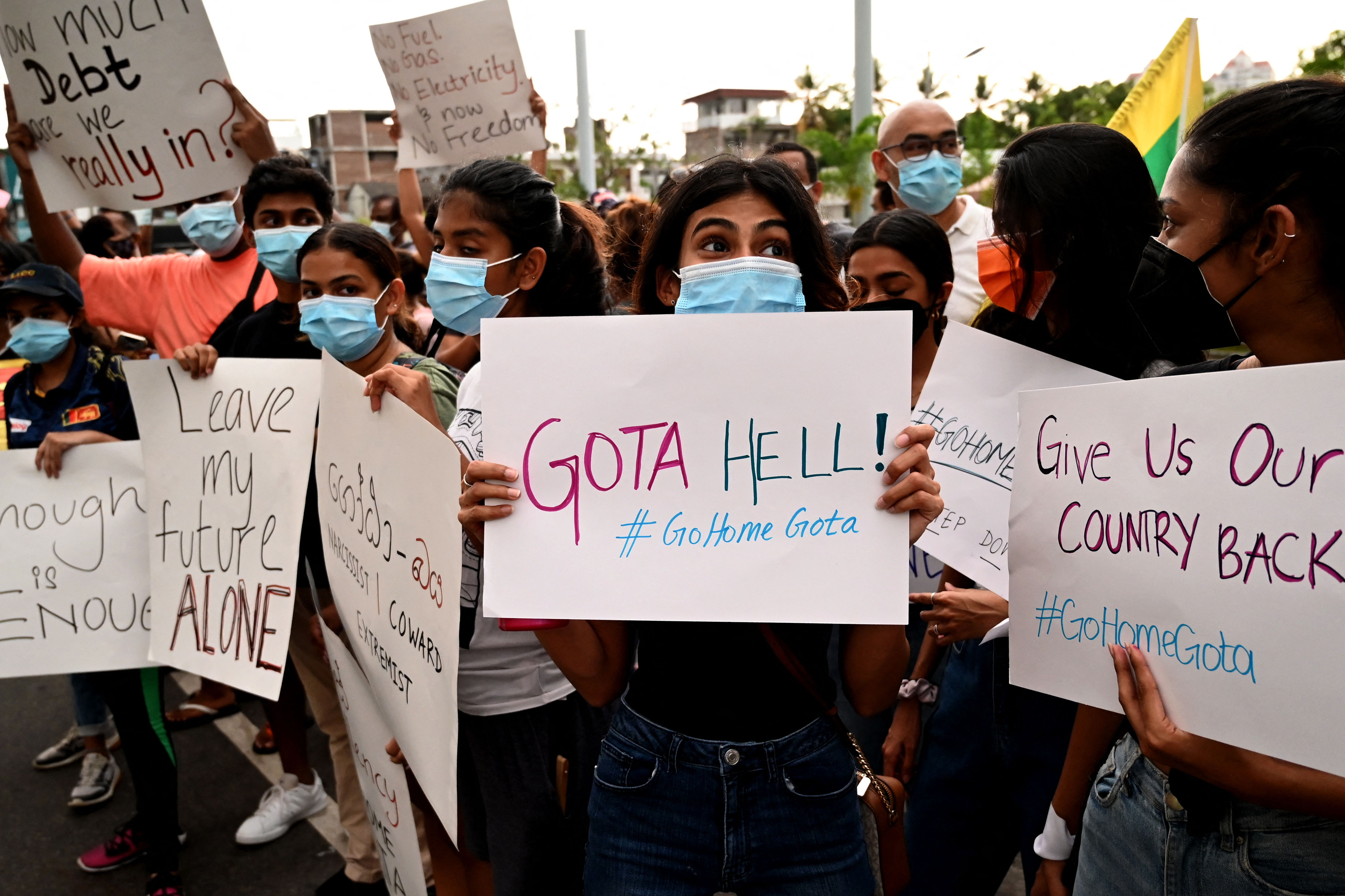 Protestors hold banners and placards during a demonstration against the surge in prices and shortage of fuel and other essential commodities in Colombo