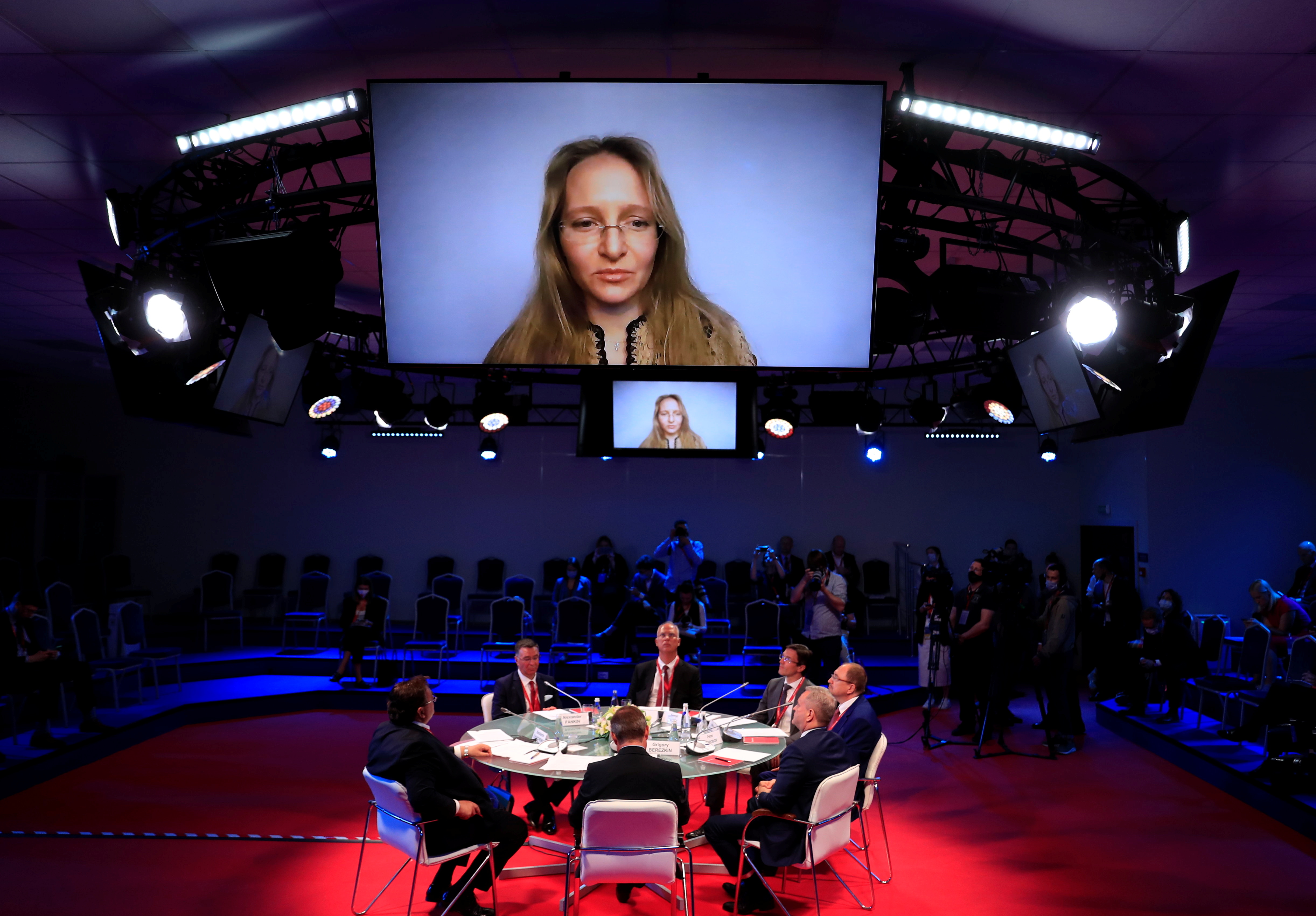 Katerina Tikhonova, with long blonde hair, seen on a large screen at a conference in St Petersburg last year 