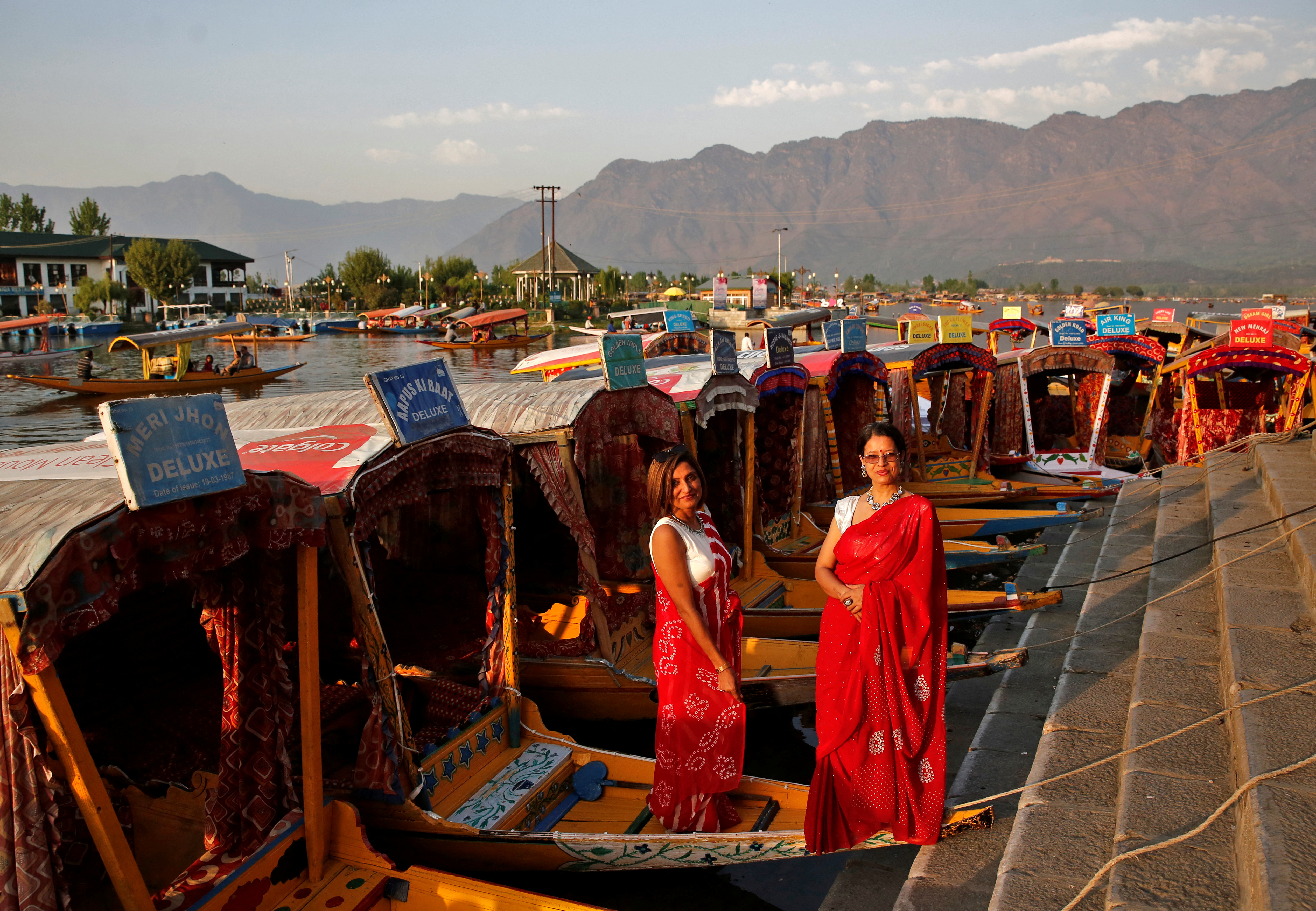 Tourists pose on parked "Shikaras"