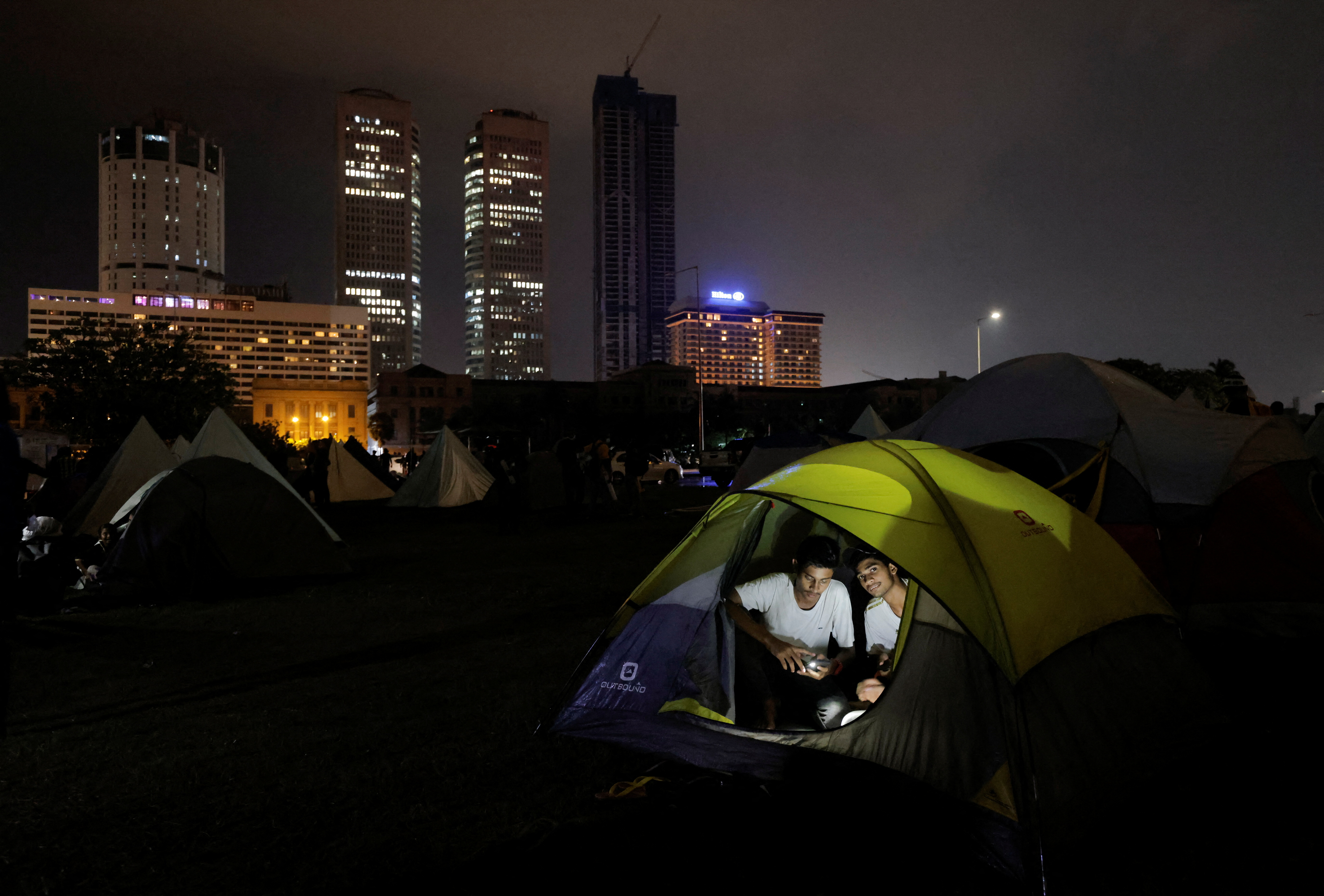 Demonstrators sit inside a tent at a protest area, dubbed the Gota-Go