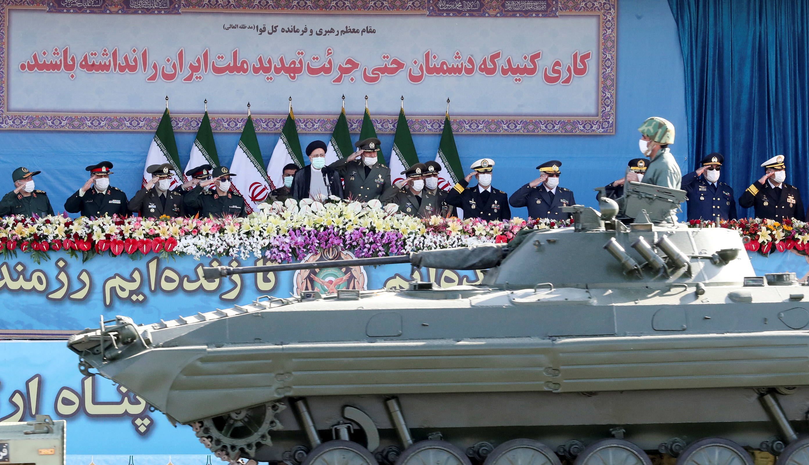 Iranian President Ebrahim Raisi and military commanders watch as military equipment passes by during a ceremony of the National Army Day parade in Tehran, Iran April 18, 2022.