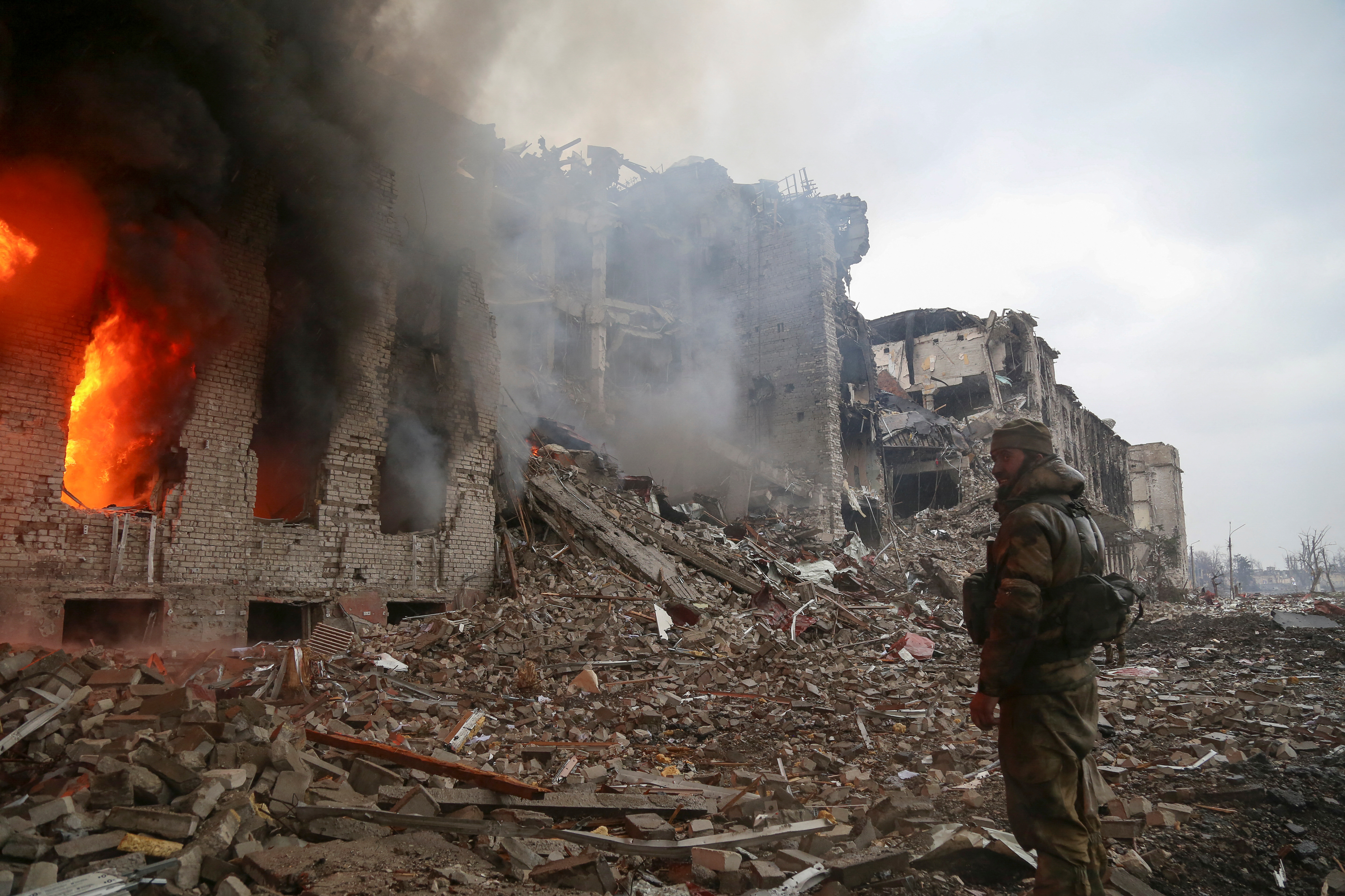 A service member of pro-Russian troops stands in front of the destroyed administration building of Azovstal Iron and Steel Works during Ukraine-Russia conflict in the southern port city of Mariupol, Ukraine 