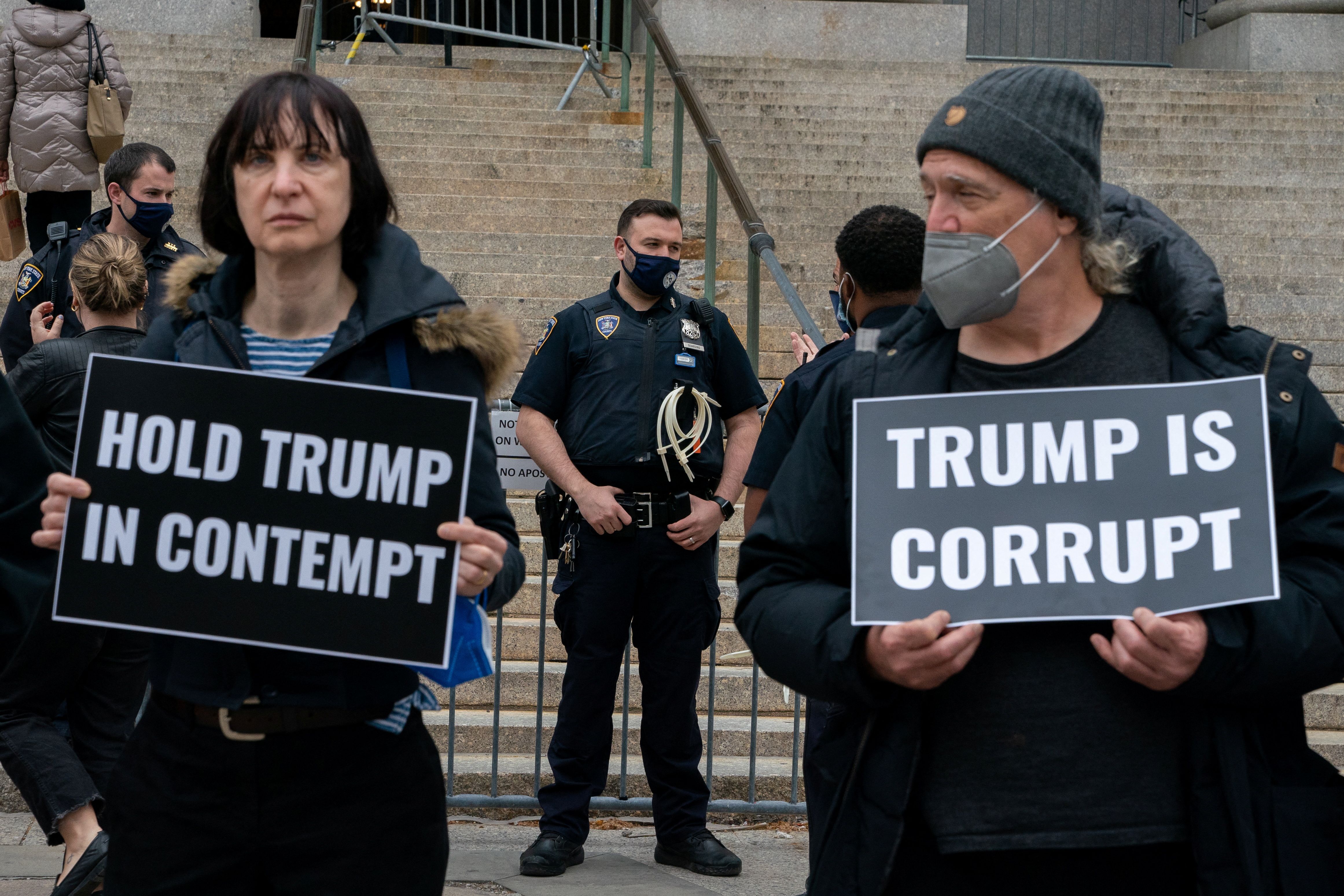 Anti-Trump demonstrators gather outside the New York County Supreme Court in New York City