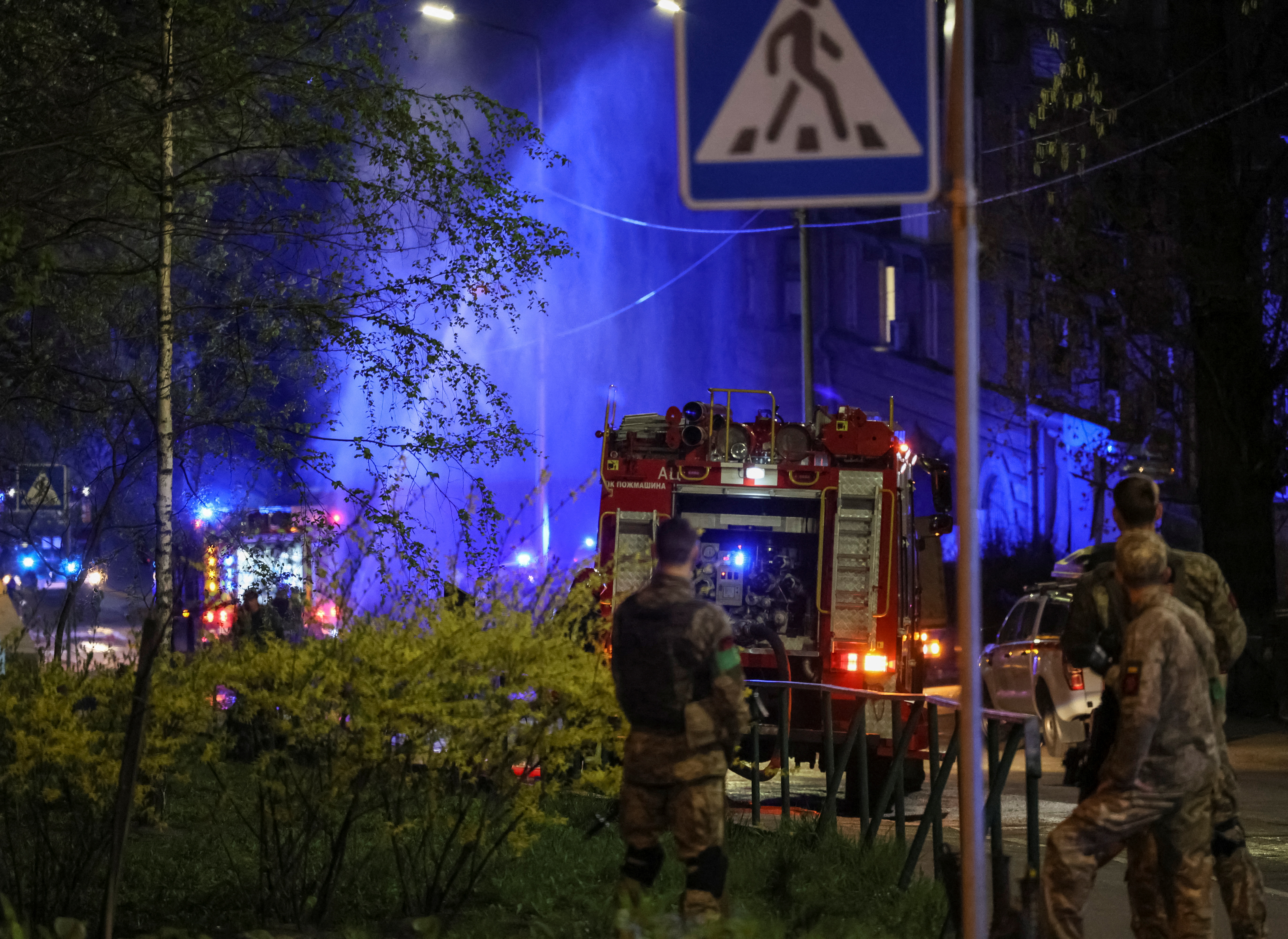 Firefighters work to put out a fire in a building after a shelling, amid Russia's invasion of Ukraine, in Kyiv, Ukraine April 28, 2022.