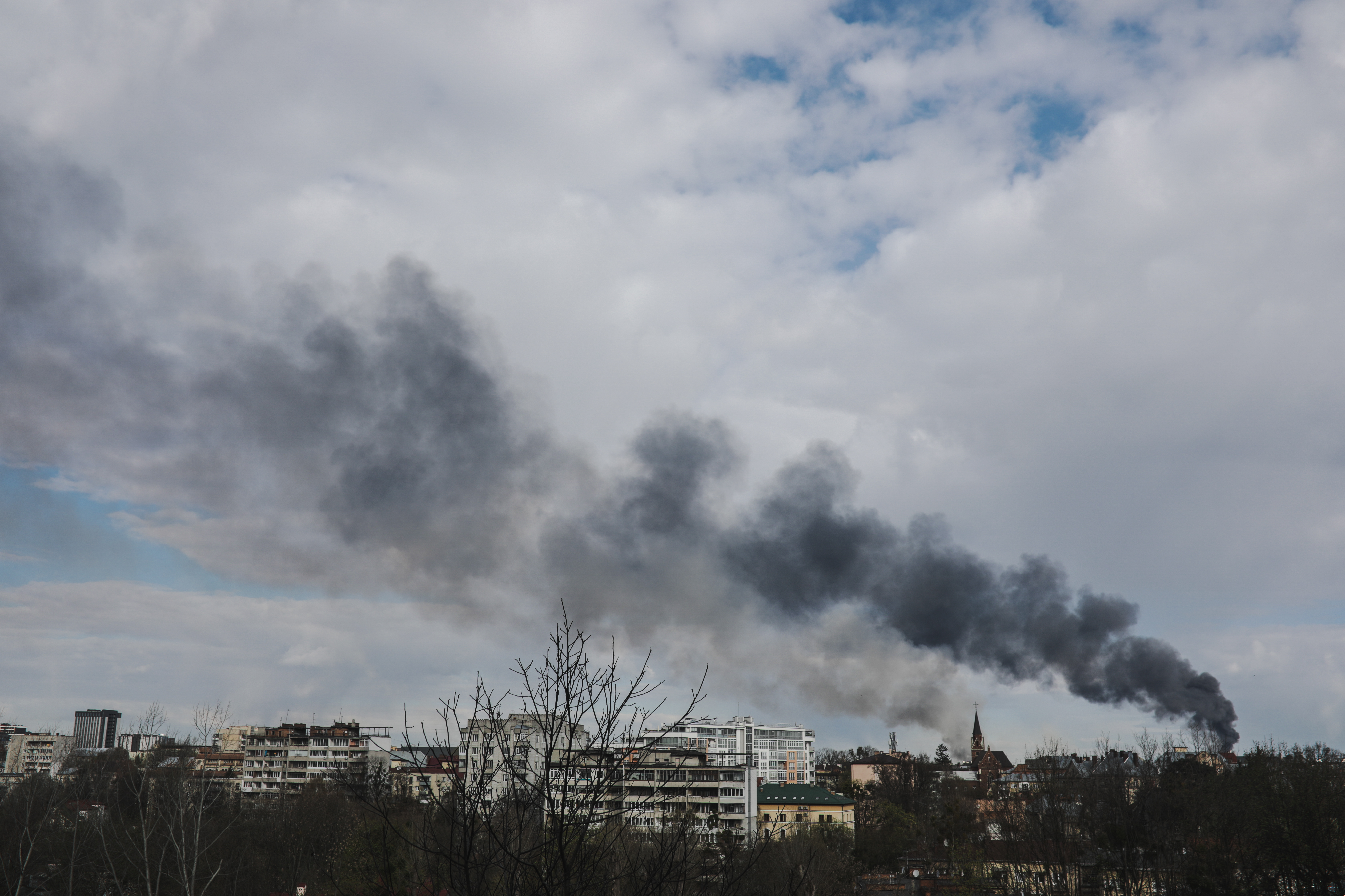 Smoke rises from buildings in Lviv reportedly after a Russian attack. 