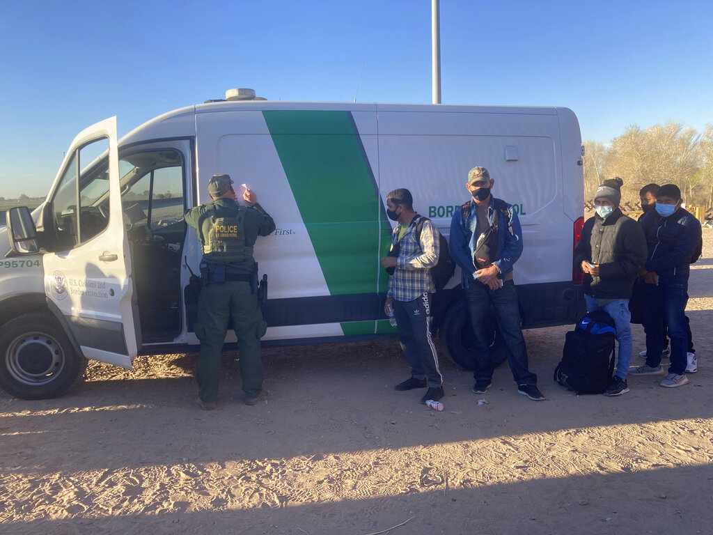 A Border Patrol agent fills out paperwork for migrants who surrendered in Yuma, Arizona