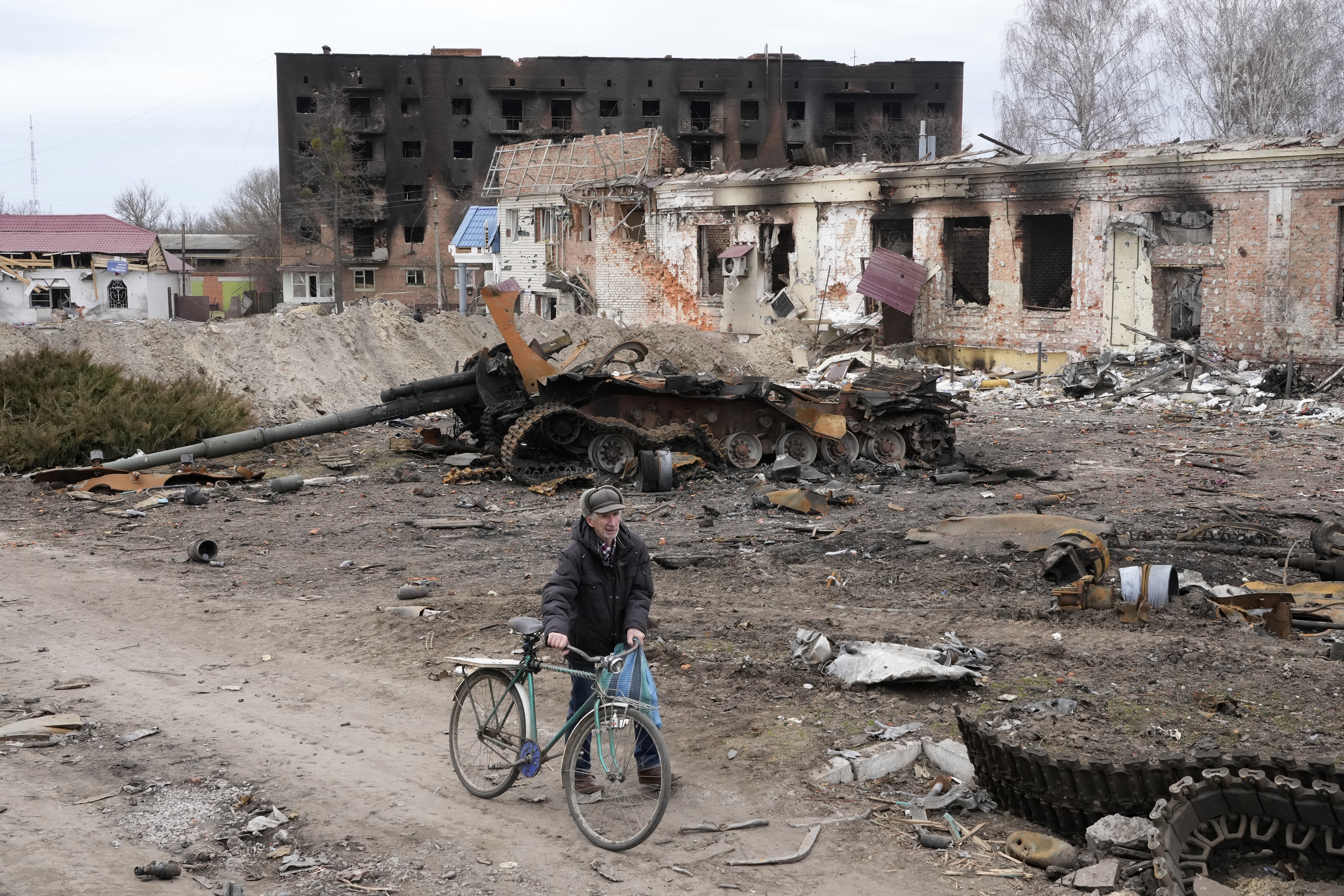 A local resident walks through the ruins of Trostsyanets 