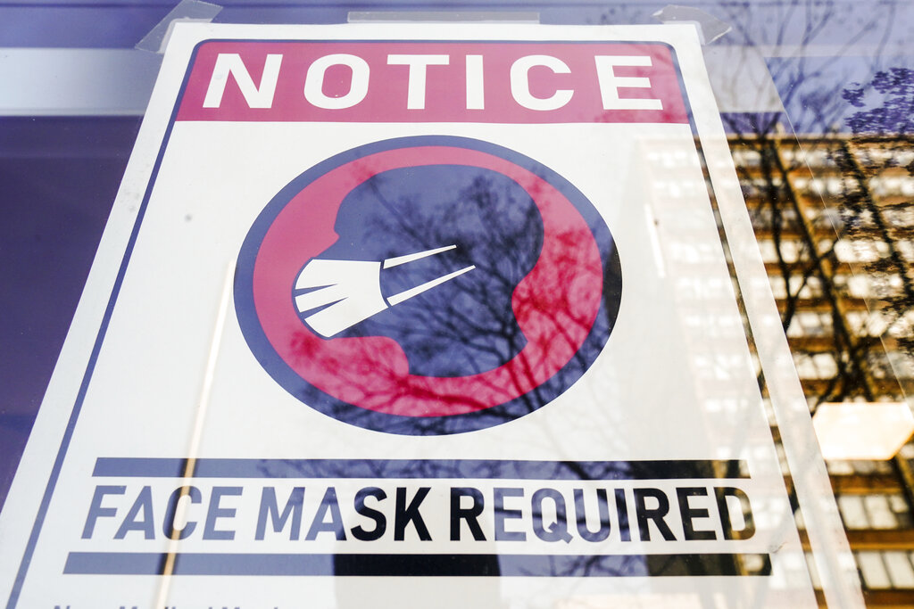 A sign requiring masks as a precaution against the spread of the coronavirus on a store front in Philadelphia.