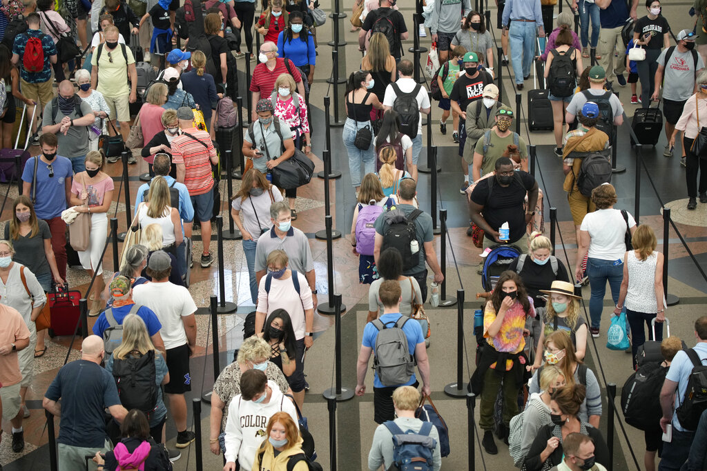 Travelers queue up in long lines to pass through the south security checkpoint in Denver International Airport.
