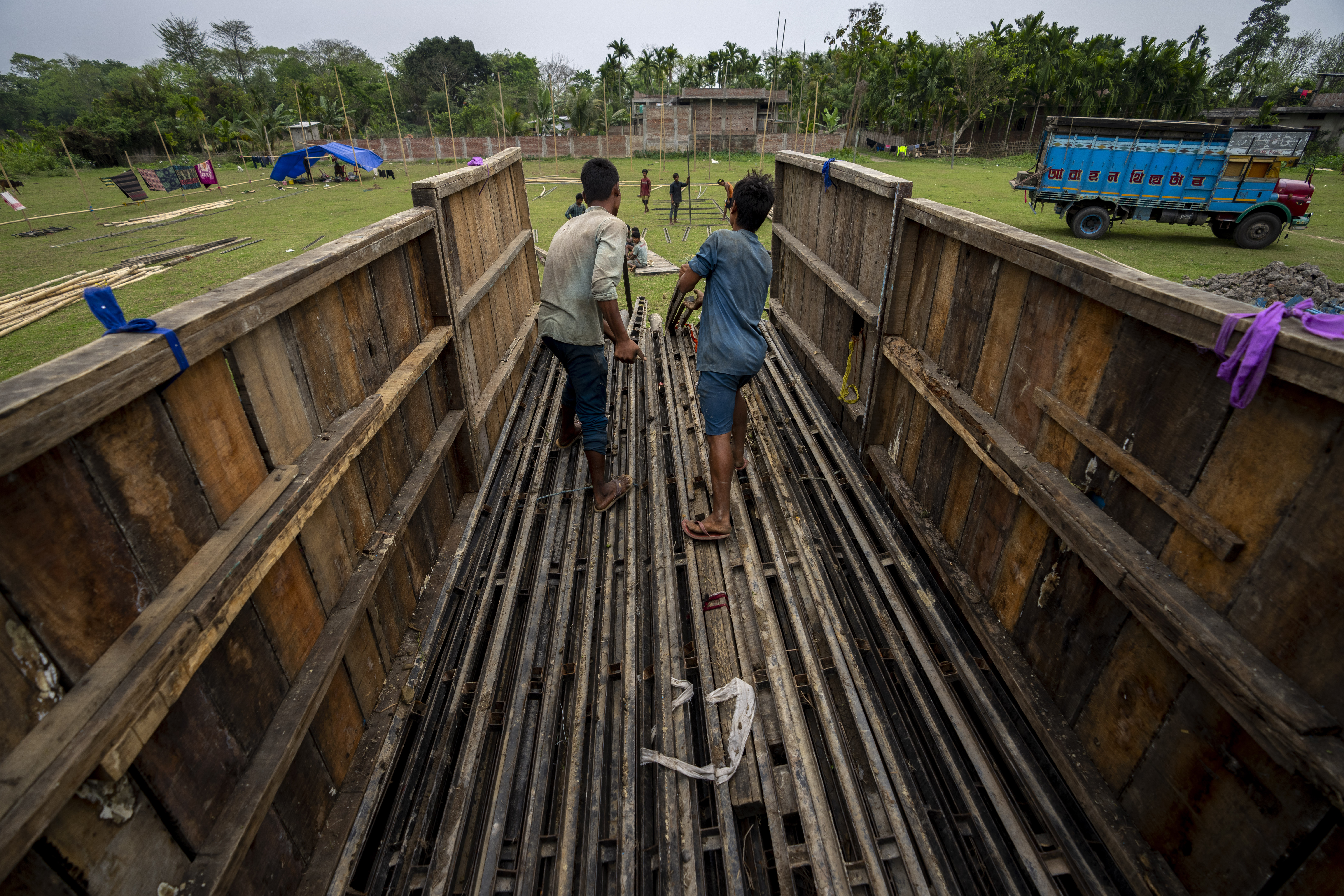 Workers of Awahan Theater unload material to build a makeshift stage and tent at