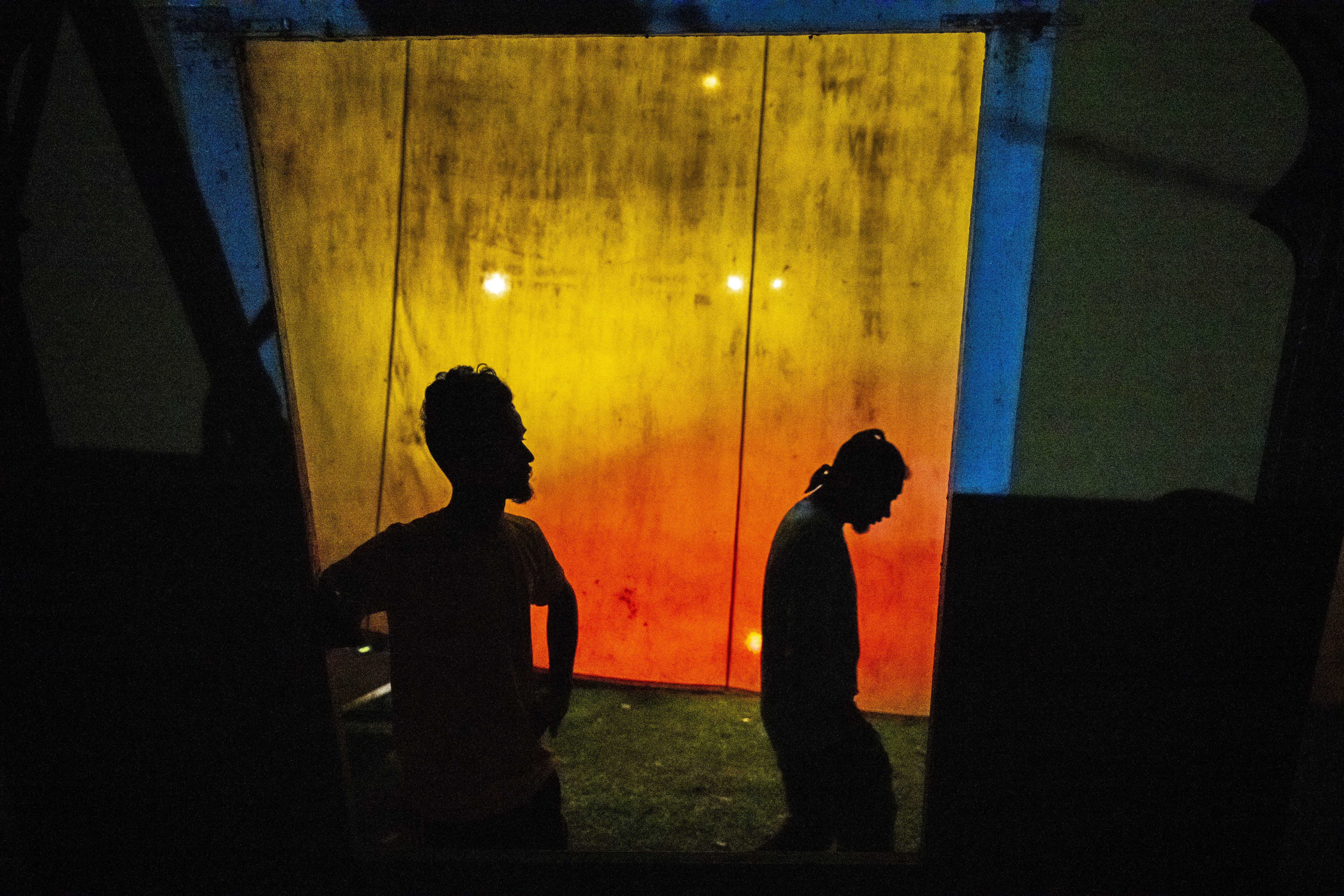 Stage workers wait to prepare a set for a performance of Awahan traveling theater at Xetali village east of Gauhati,