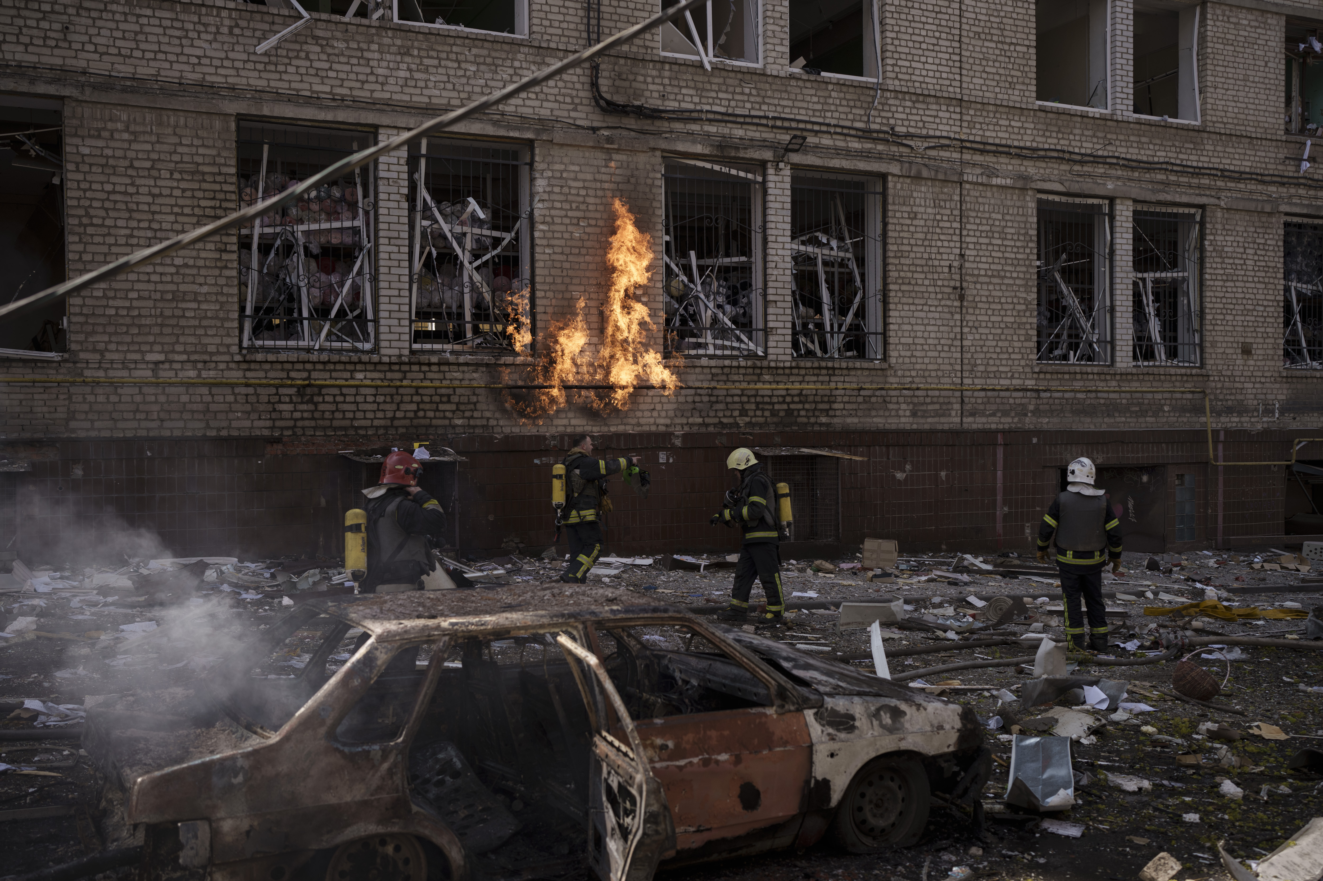 Firefighters work to extinguish multiple fires after a Russian attack in Kharkiv