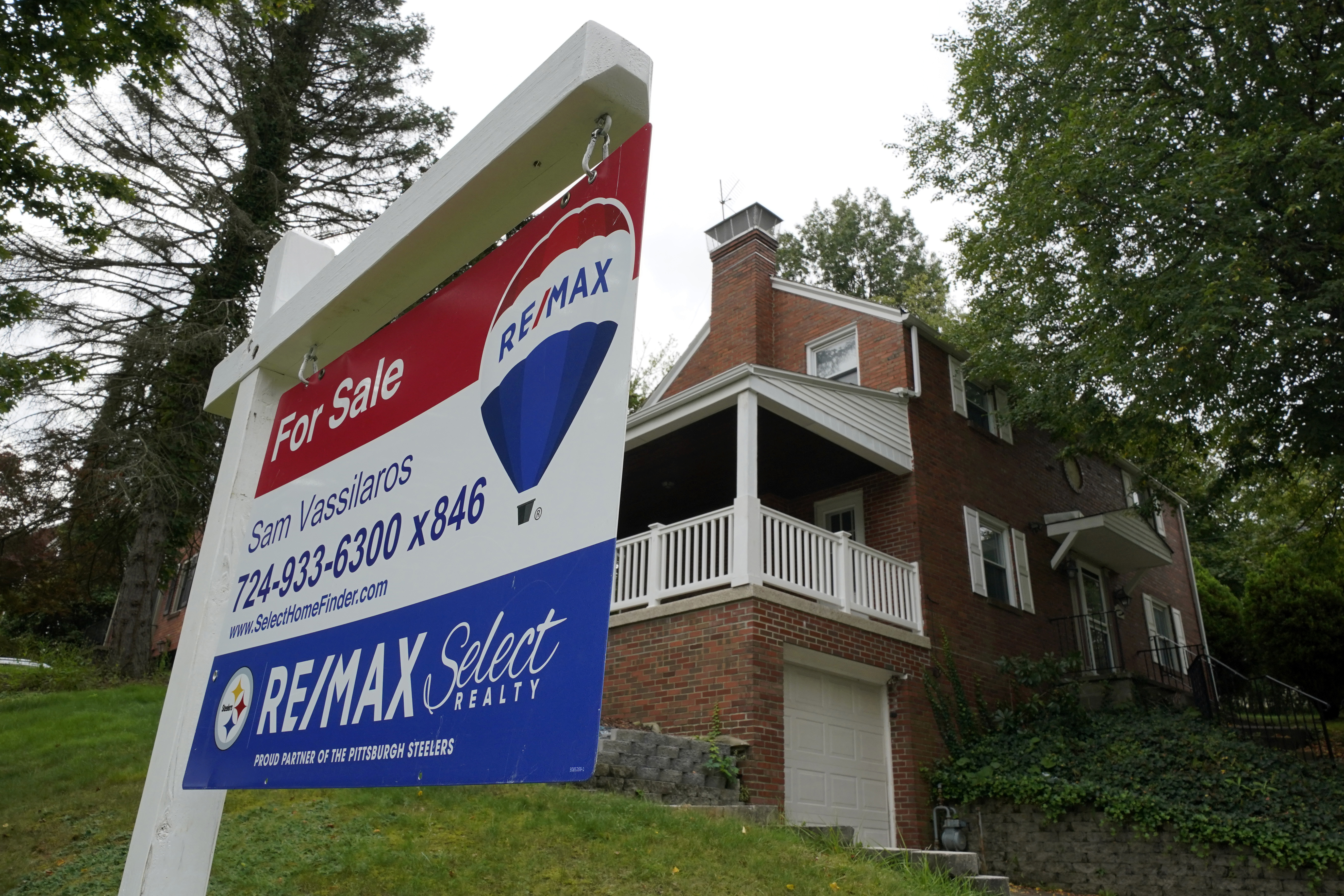 A for sale sign is displayed outside a home in Mount Lebanon, Pa