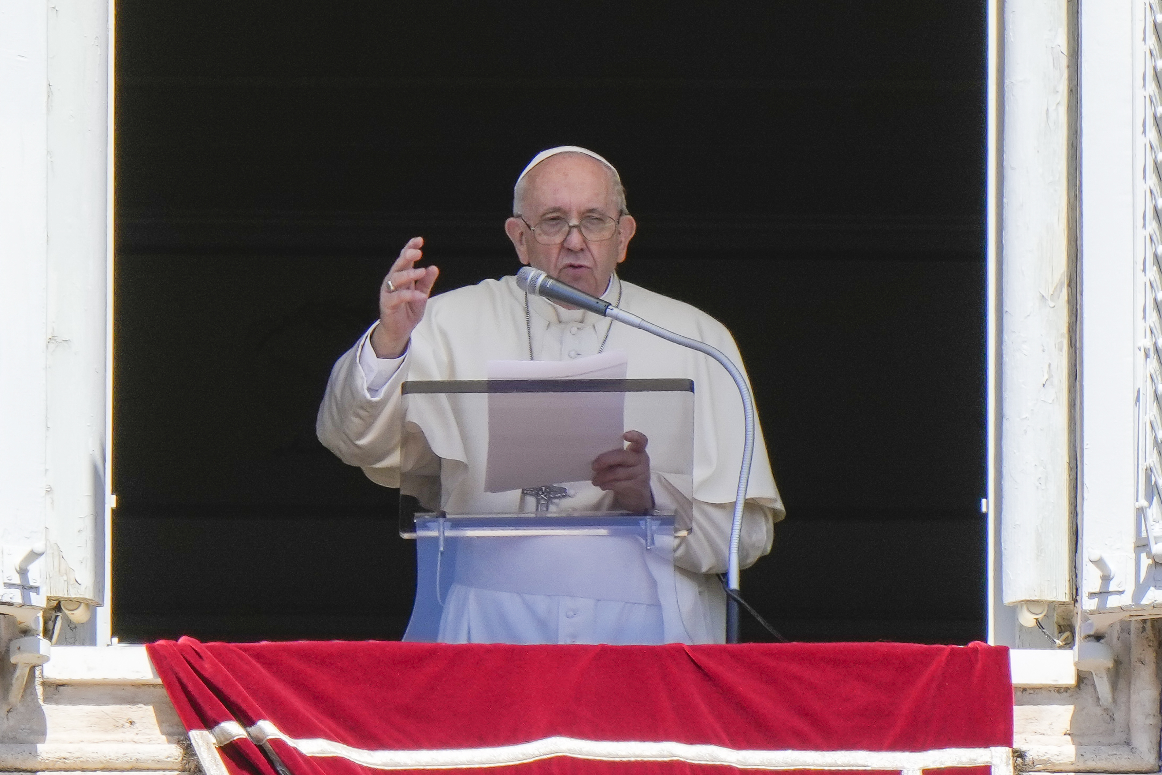 Pope Francis delivers his blessing as he recites the Regina Coeli noon prayer from the window of his studio overlooking St.Peter's Square, at the Vatican.